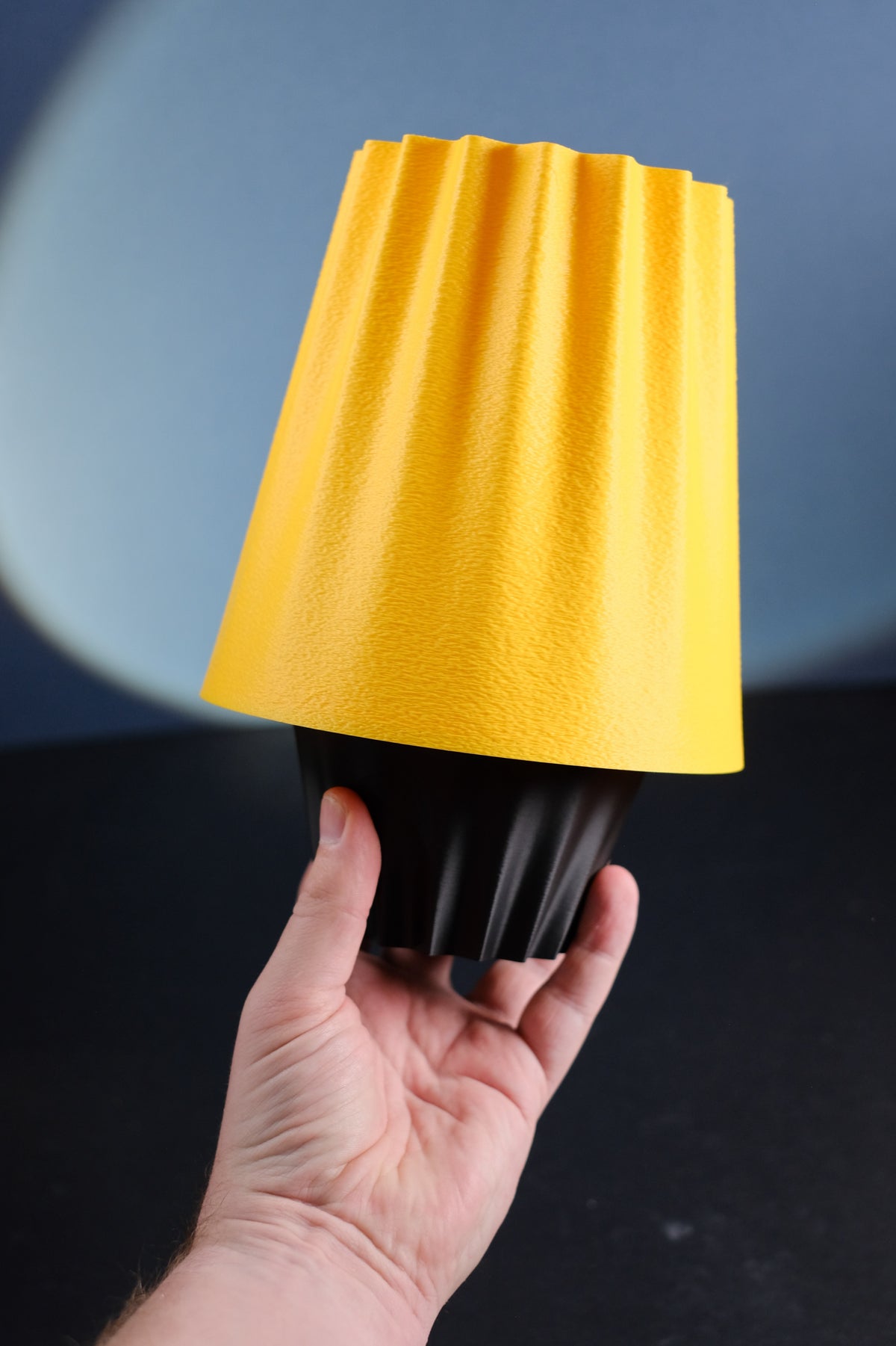 Fluted Ambient Desk Lamp with an amber shade and black fluted base