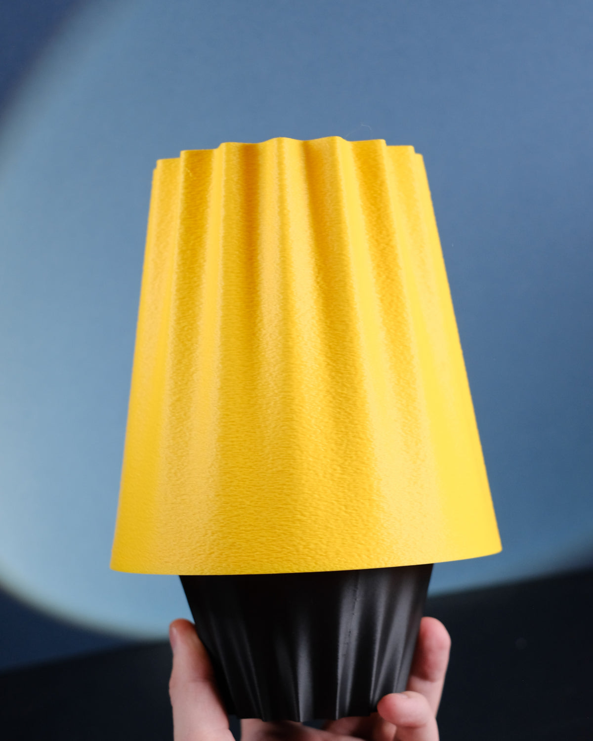 Fluted Ambient Desk Lamp casting a warm amber glow in a dark room