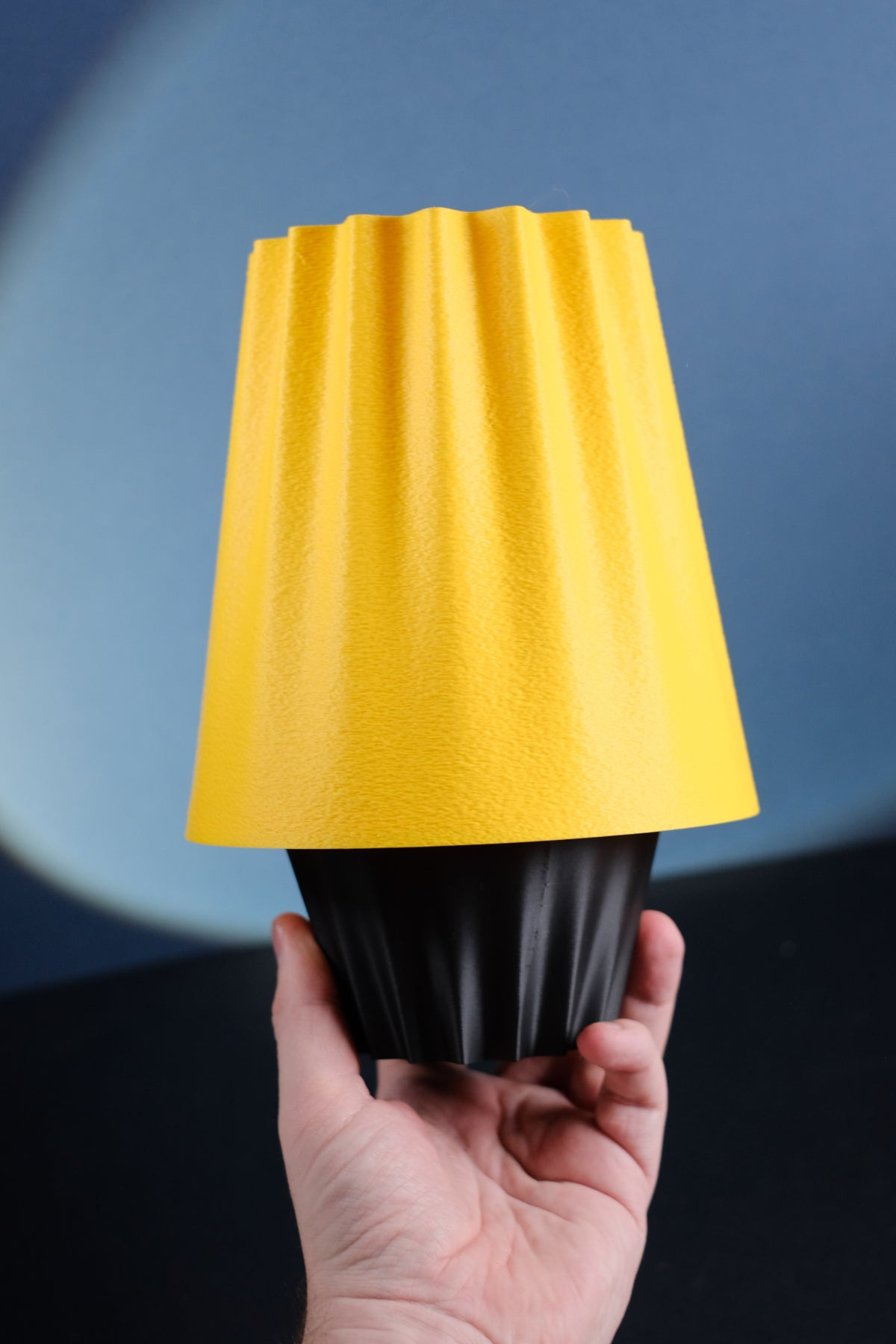 Close-up of the fluted amber shade and black lamp base