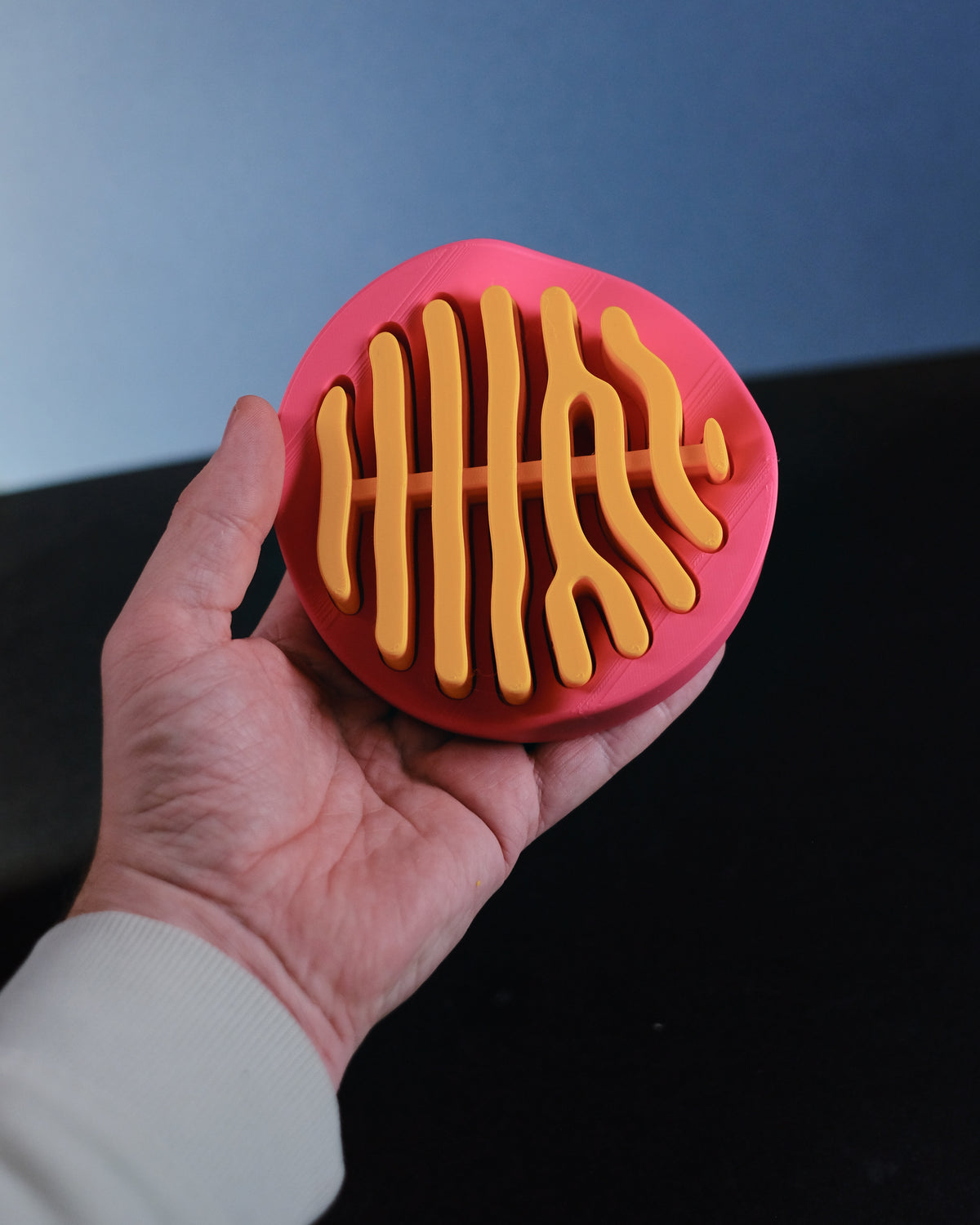 Coral coaster set held in hands