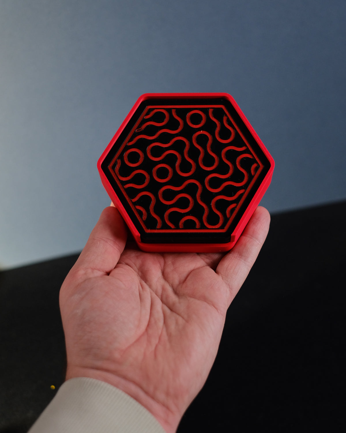 Hexagonal coaster holder held in hand