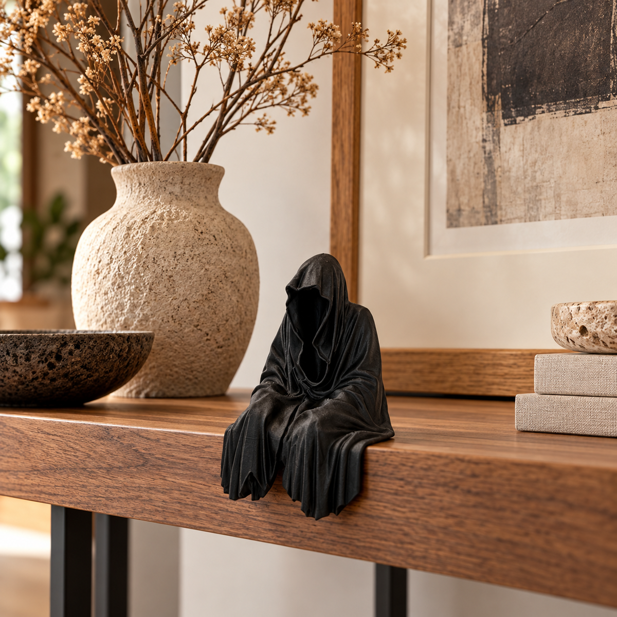 Black Grim Reaper Chillin seated decorative figure styled on a wooden console with neutral home décor