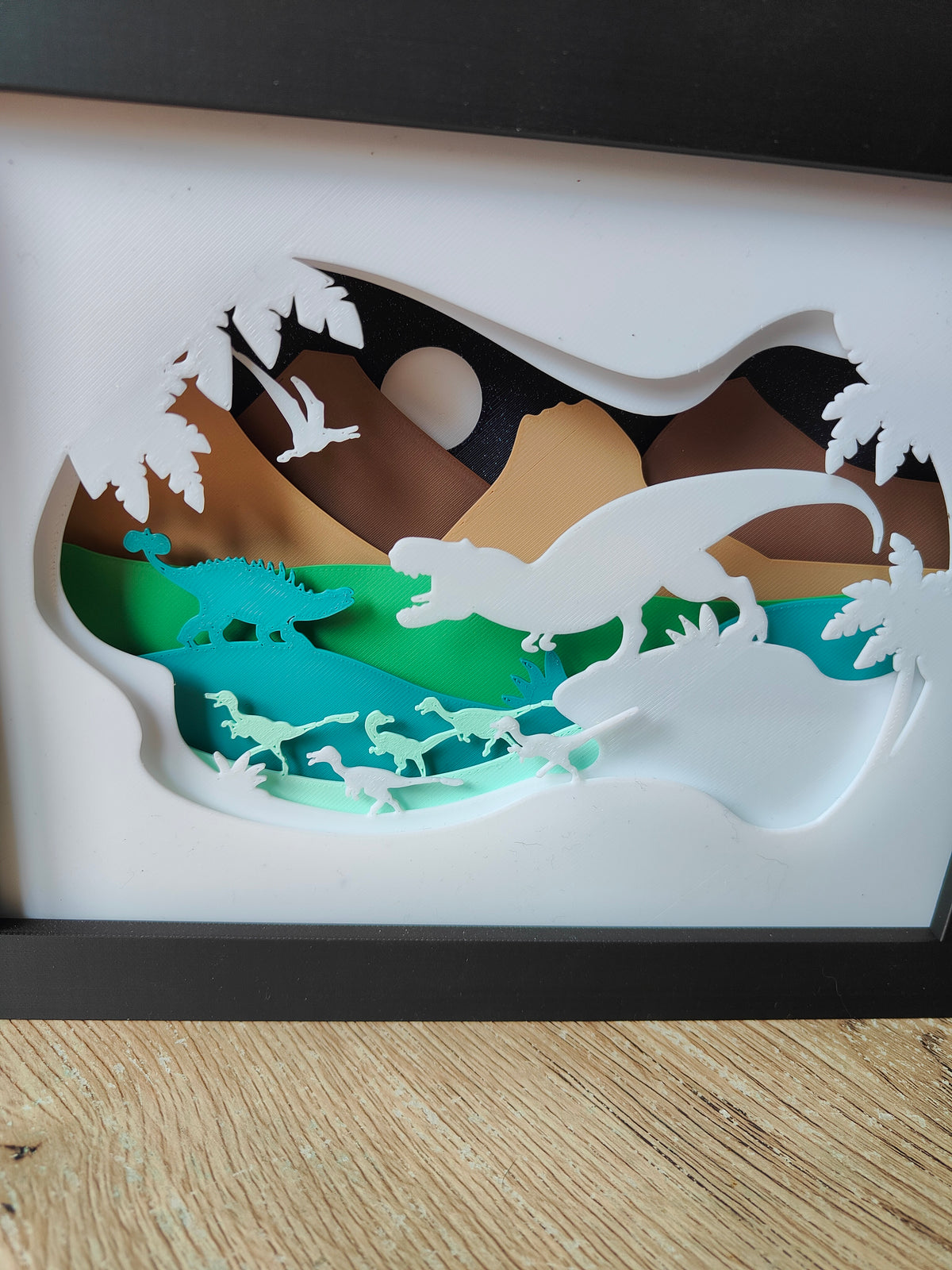 Dinosaur shadow box - close up front view showing full prehistoric scene with moonlit sky