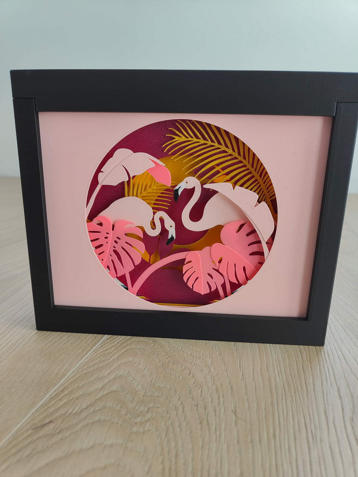 Flamingo Paradise shadow box - front view unlit on wooden surface