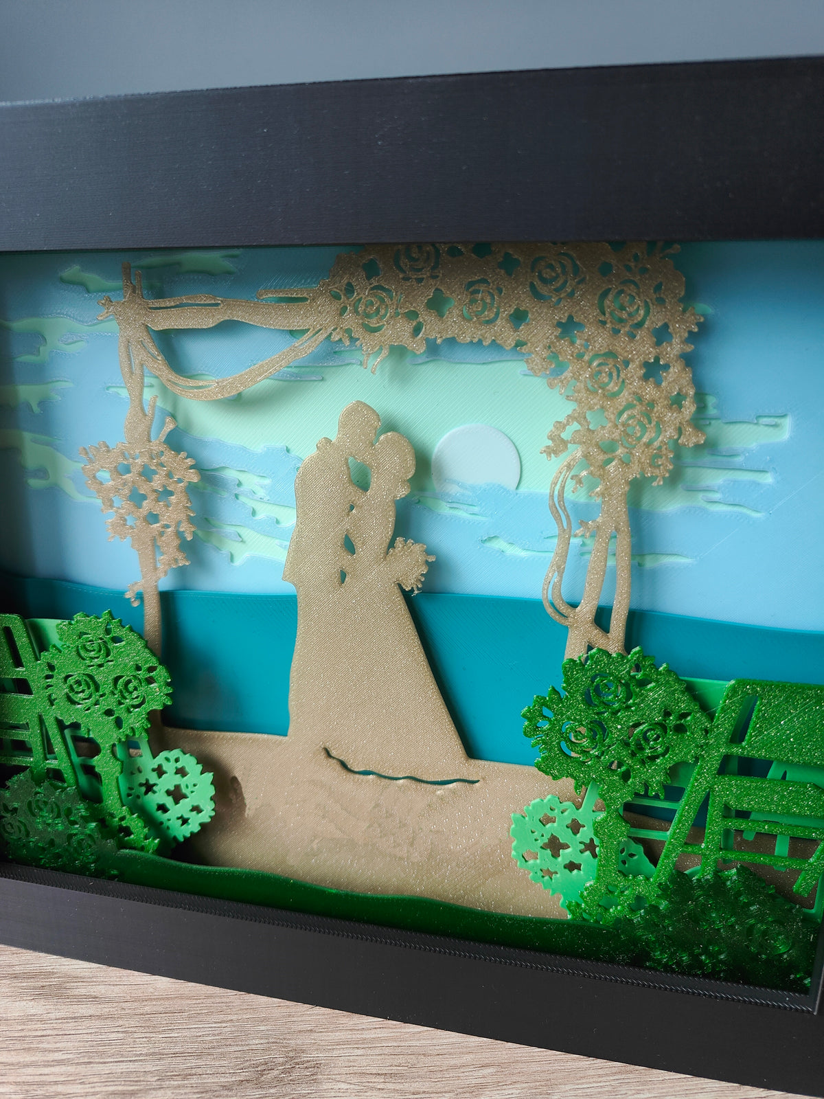Wedding shadow box - close up of bride and groom silhouette and floral arch detail