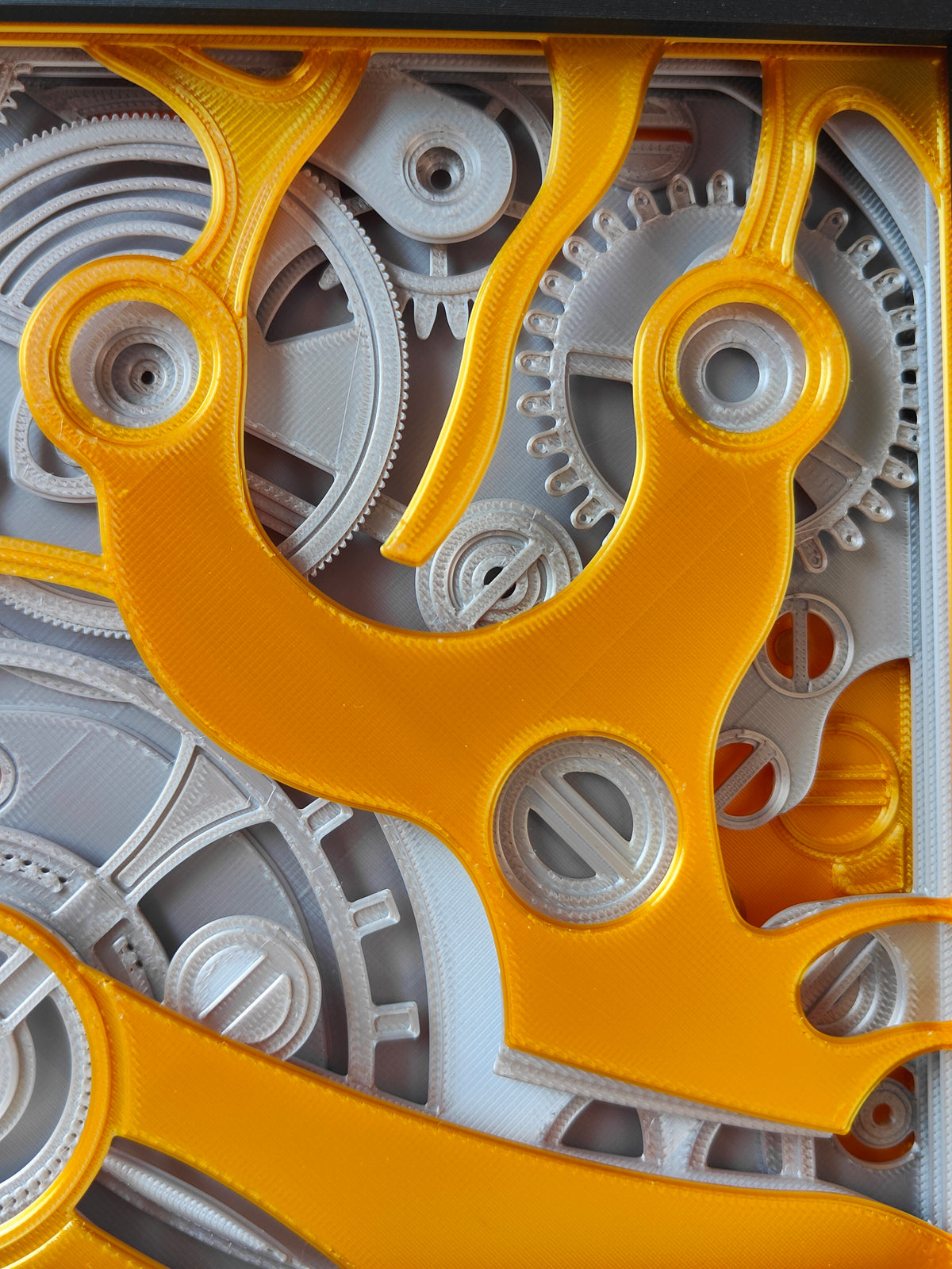 Clockwork shadow box - close up of gold escapement fork and silver gear detail
