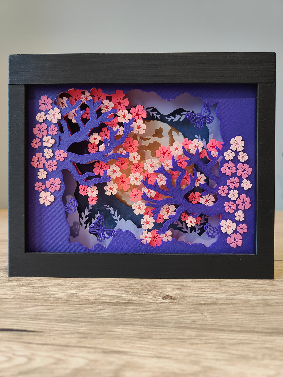 Sakura shadow box - front view with purple cherry blossom trees and pink flowers on deep blue background