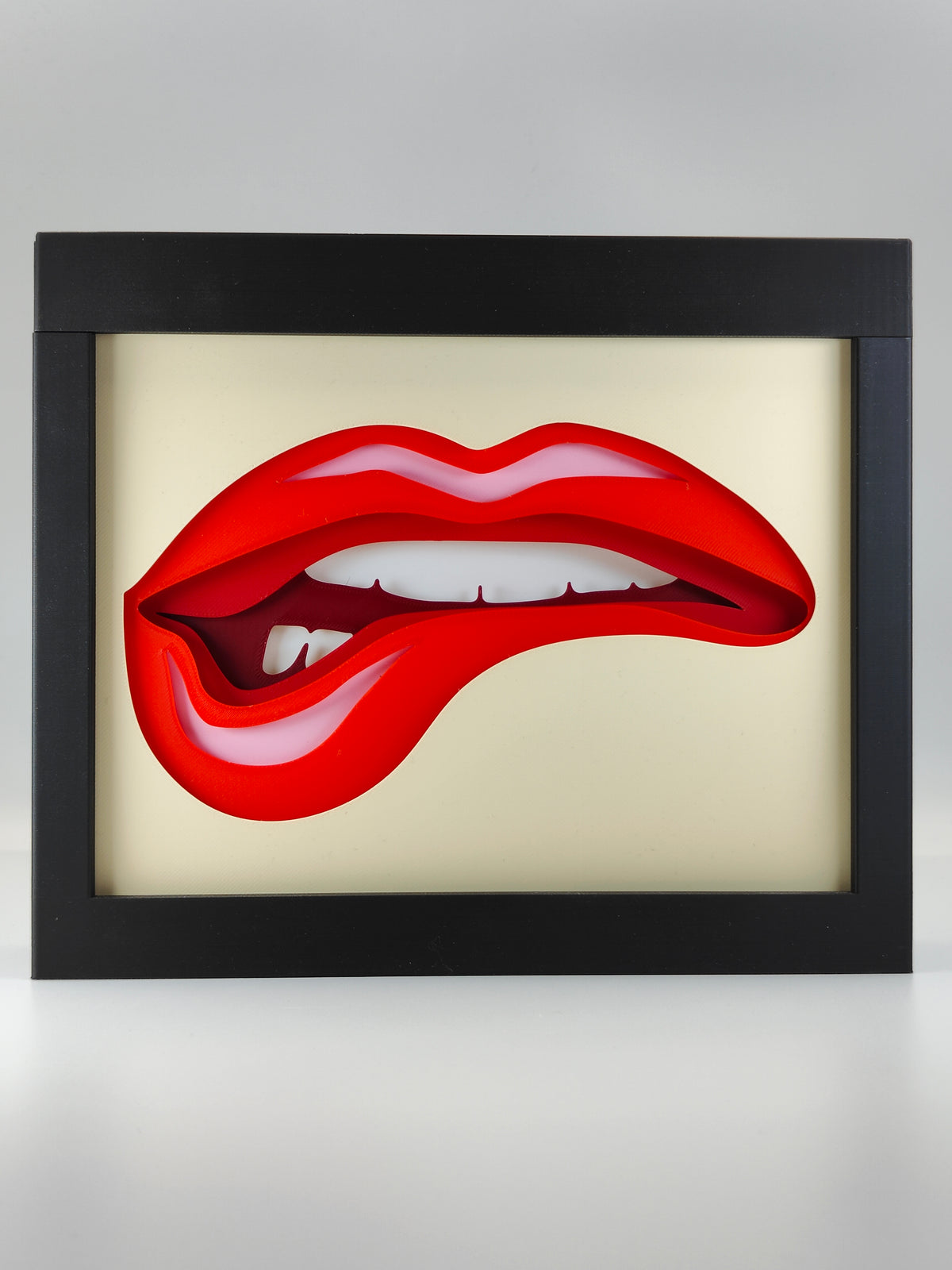 Lips Shadow Box 2 - front view showing bold red lips with tongue on cream background