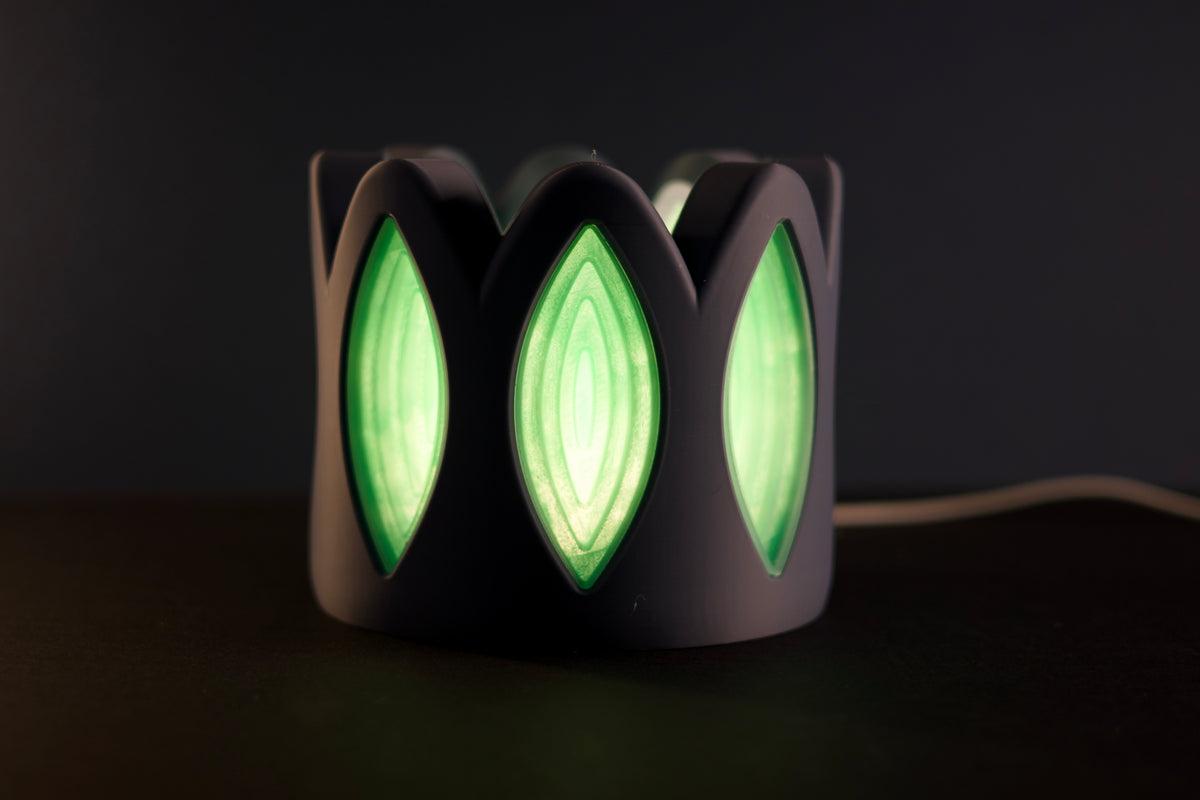 Whimsical Window Desktop Lamp close up side view neon green glow through petal windows dark background