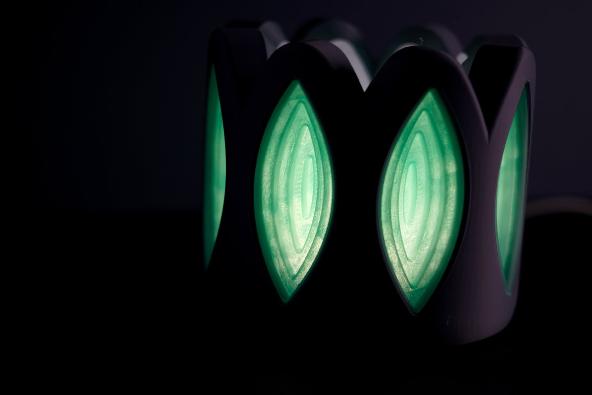 Whimsical Window Desktop Lamp top angled view inside glow visible petal cutouts dark background