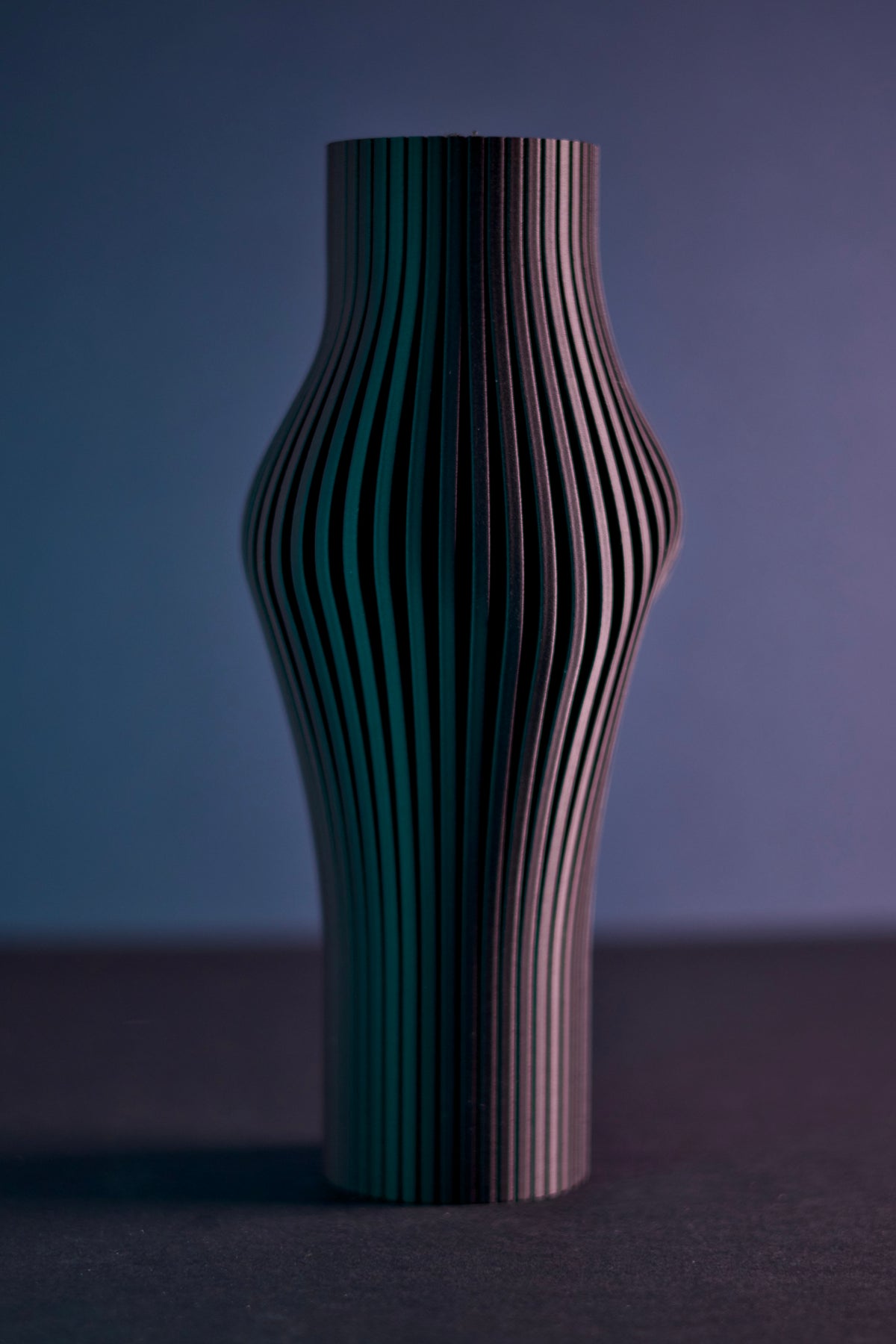 Elegant Sculpted Ribbed Vase black held in hands close up showing ribbed texture editorial