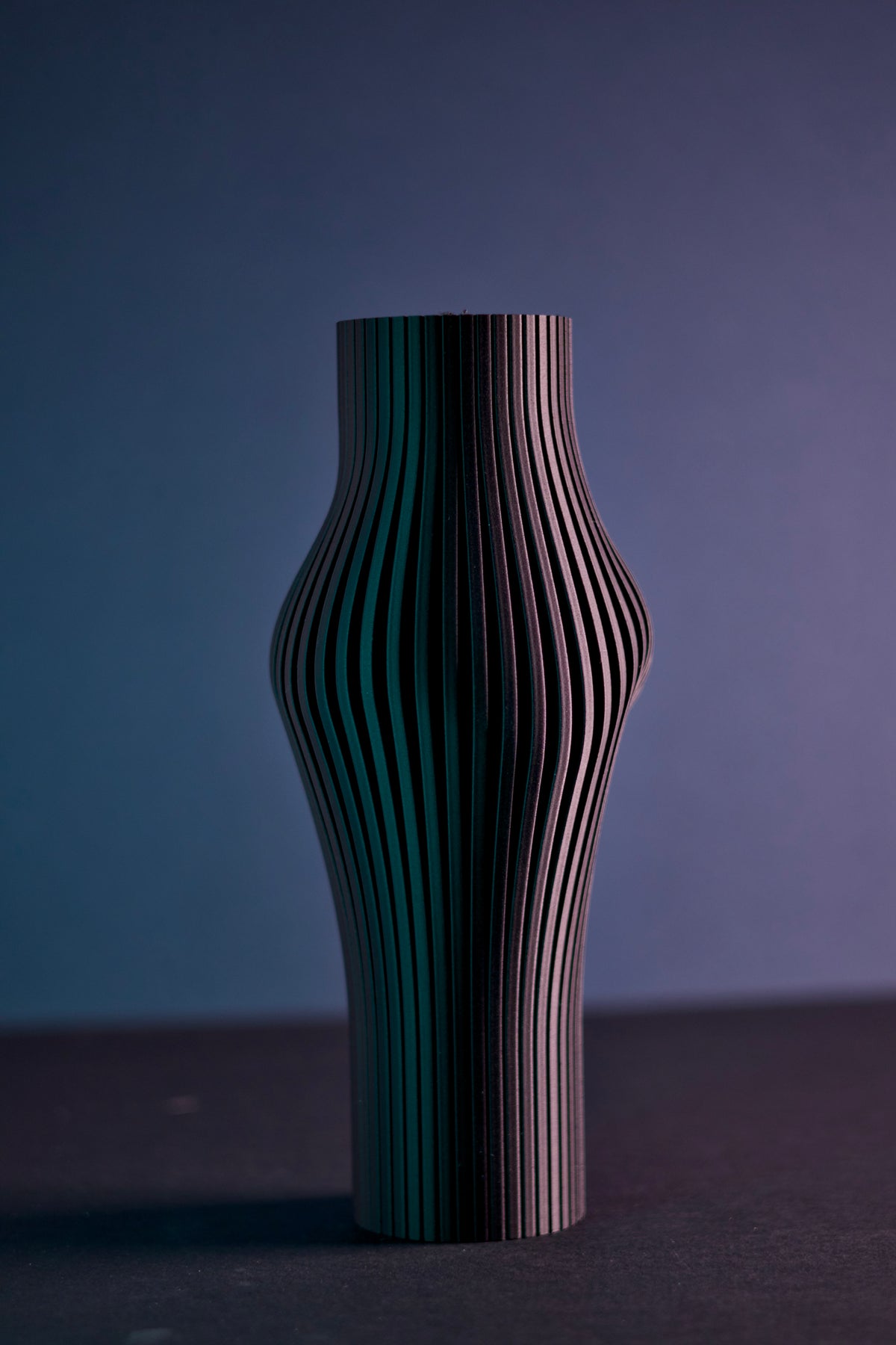 Elegant Sculpted Ribbed Vase black on walnut sideboard with candlelight warm moody interior