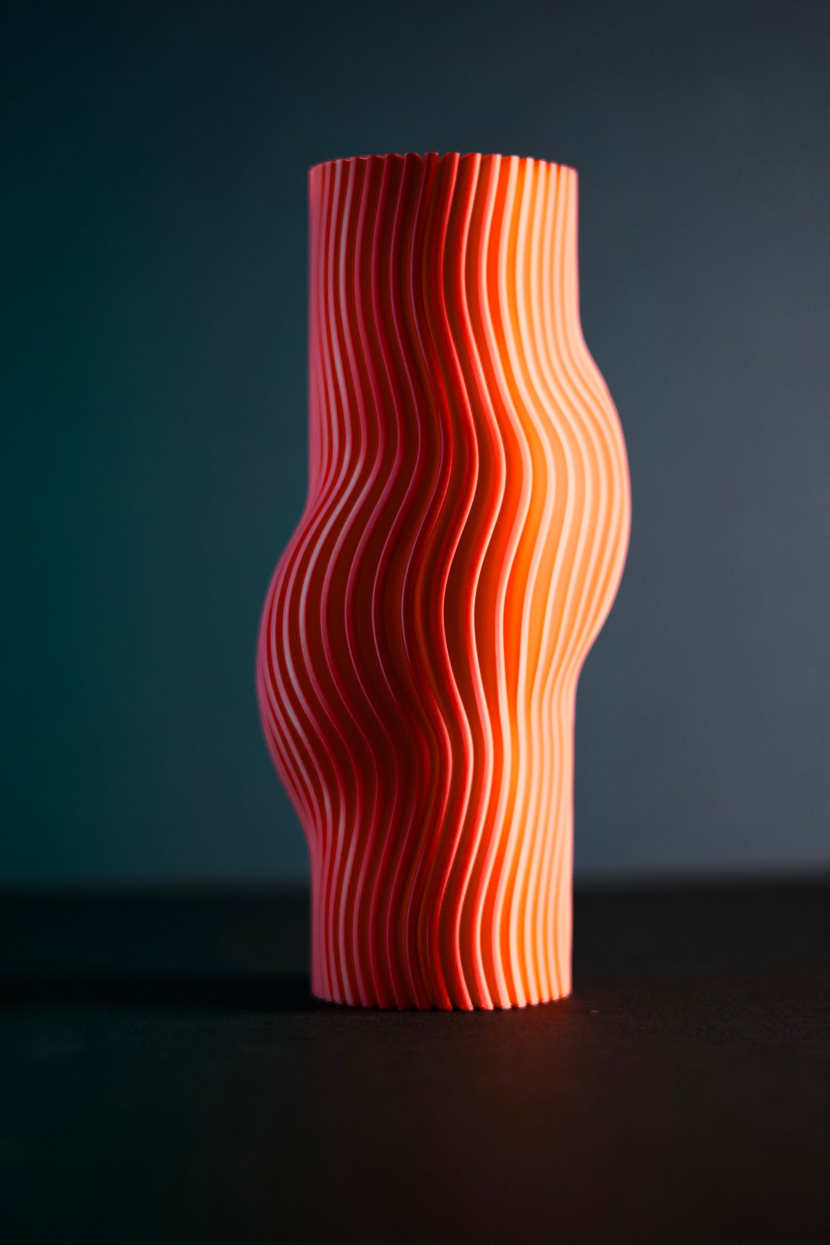 Elegant Ribbed Flow Vase pink with pastel geometric props on light grey background studio shot