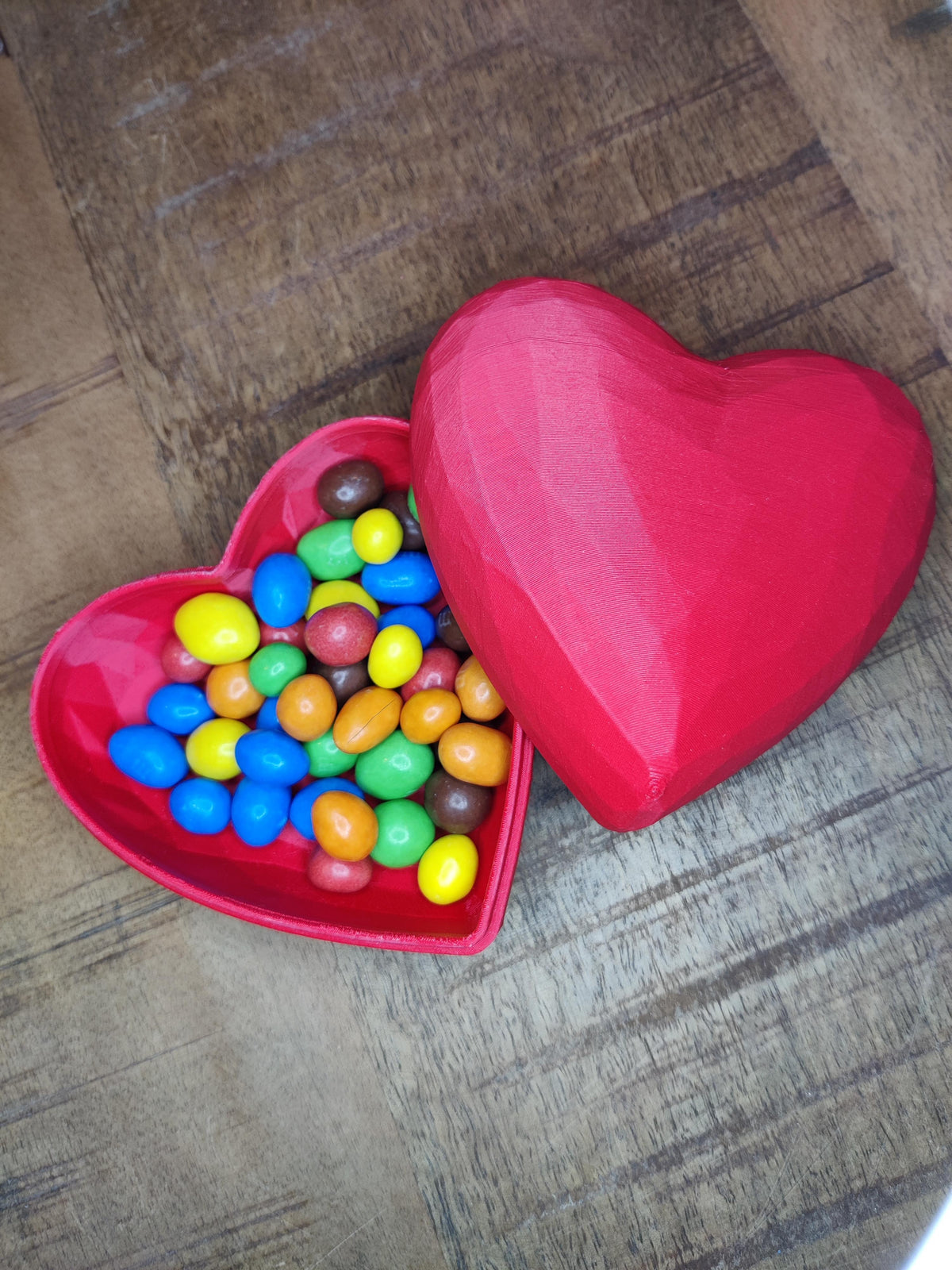 Heart-shaped gift box closed - orange, top angle