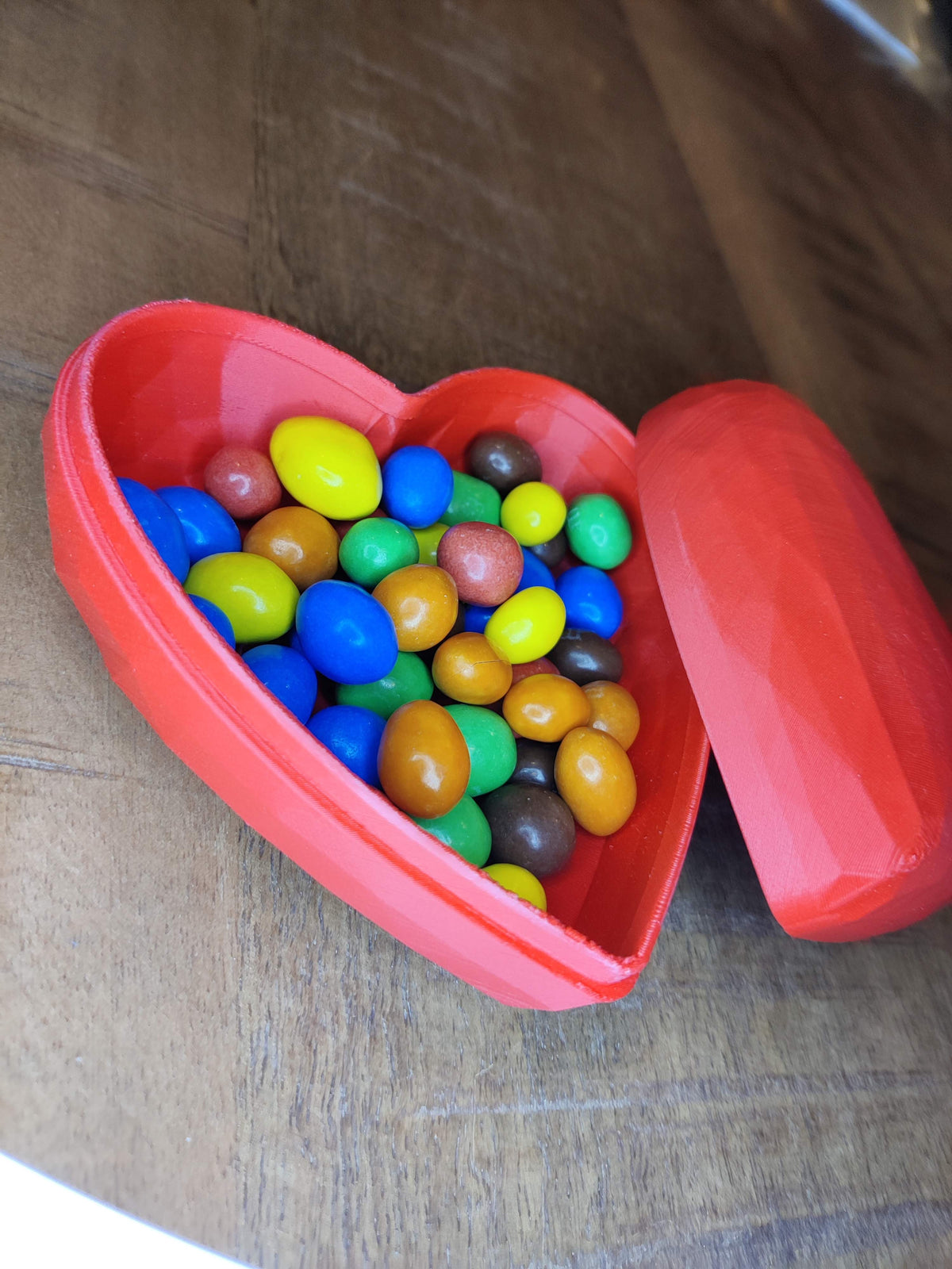 Heart-shaped gift box closed - orange, angled view