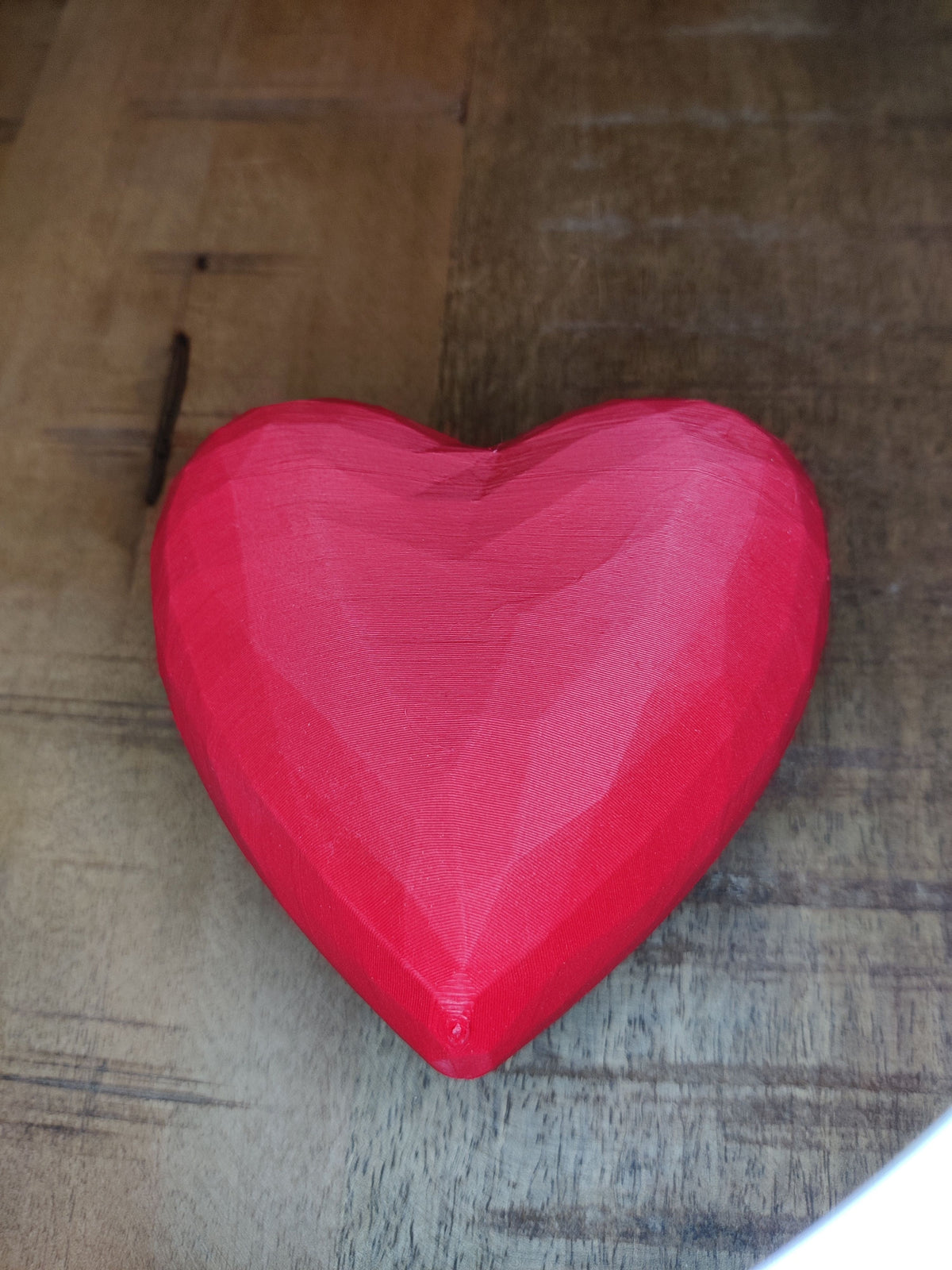 Heart-shaped gift box closed - orange, low angle