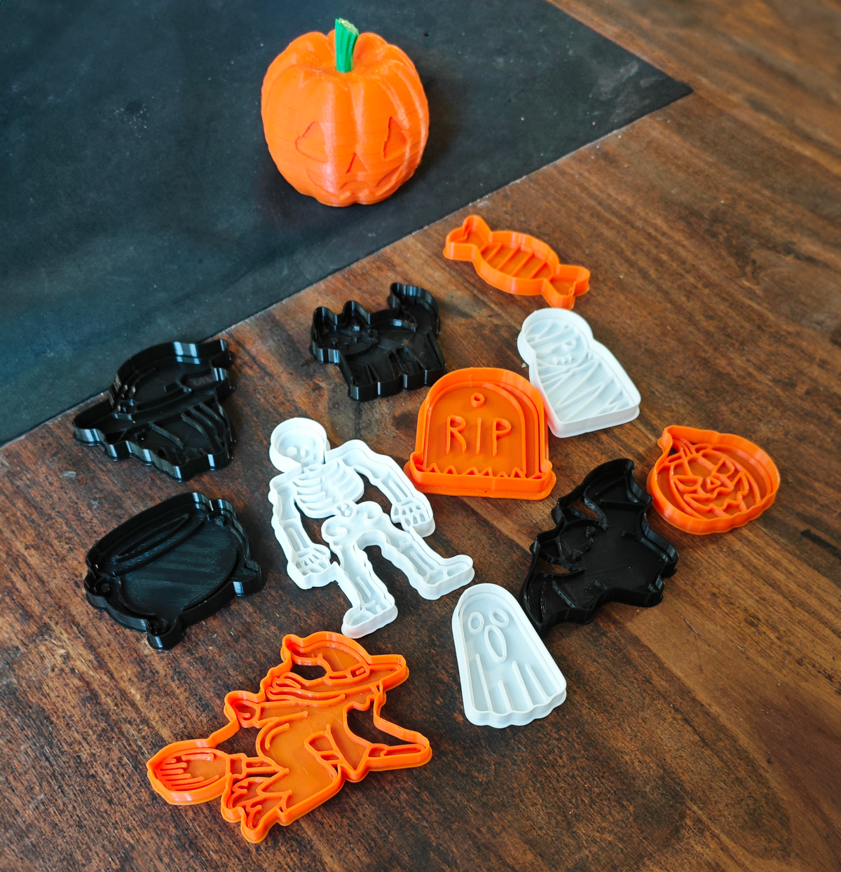 Halloween cookie cutter set arranged beside decorated seasonal biscuits