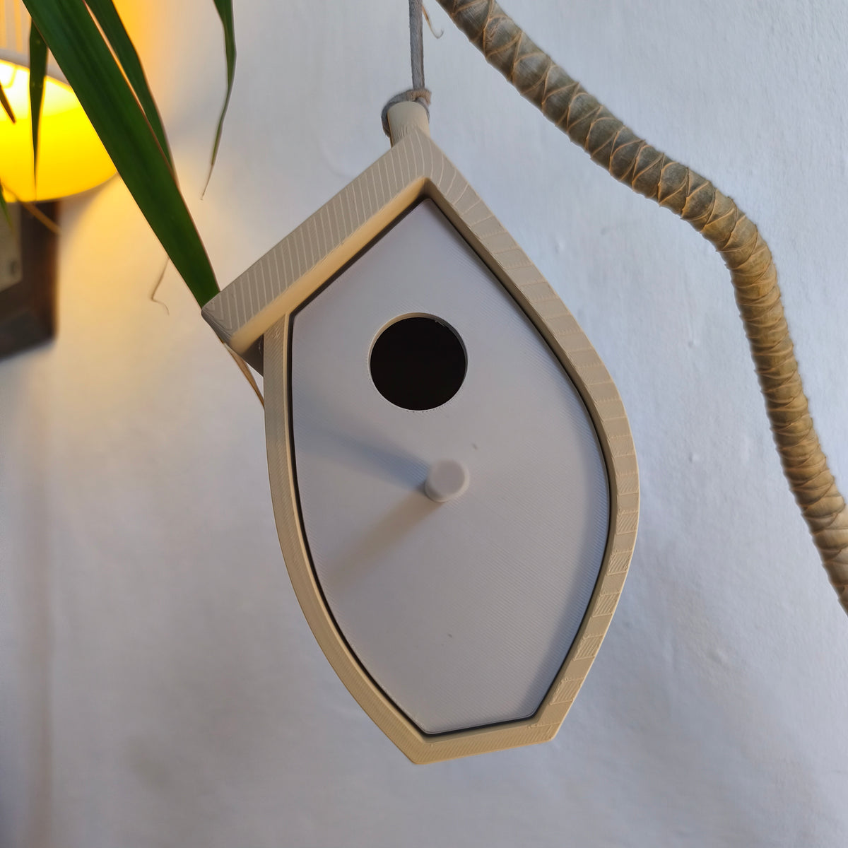 Close angled view of birdhouse and hanging loop