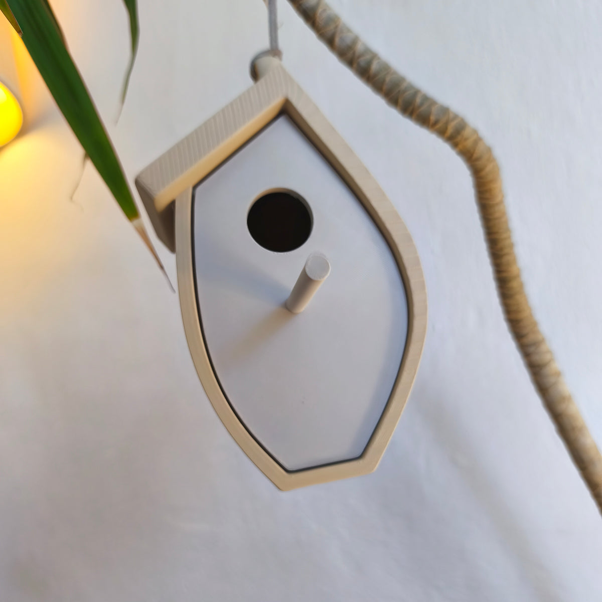 Birdhouse displayed on a pale table