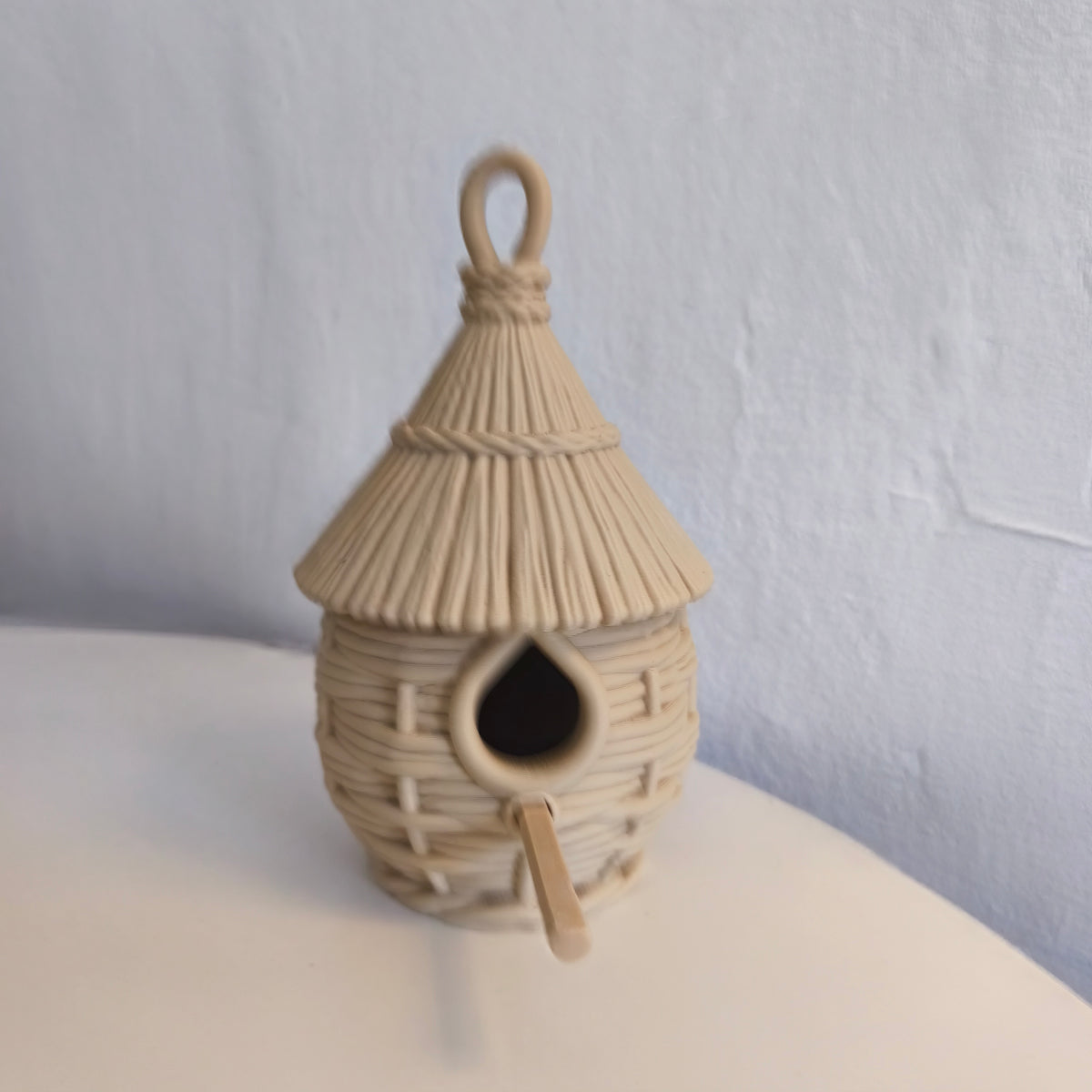 Weave Birdhouse hanging among foliage