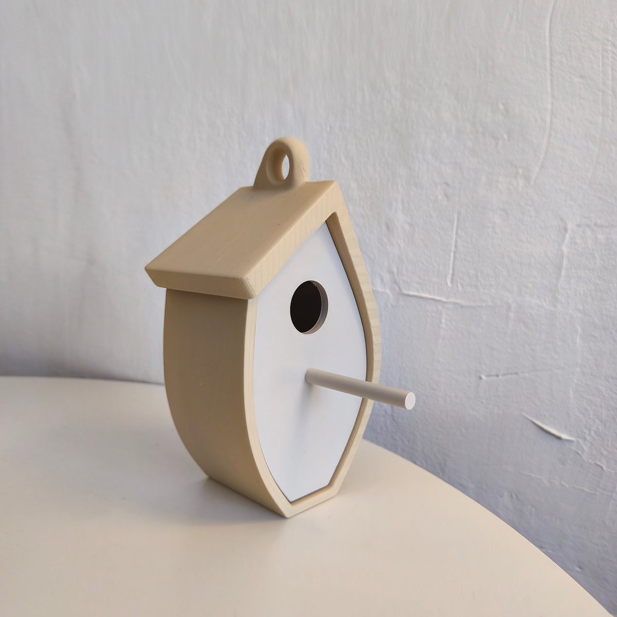 Side angle of beige birdhouse