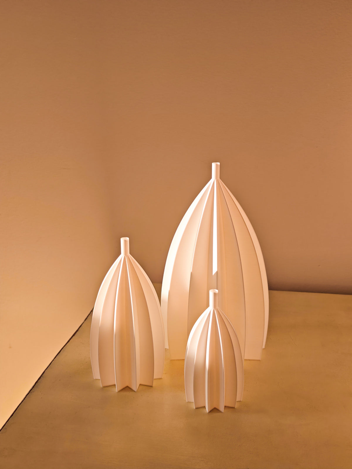 Three glowing pumpkins on a dark tabletop