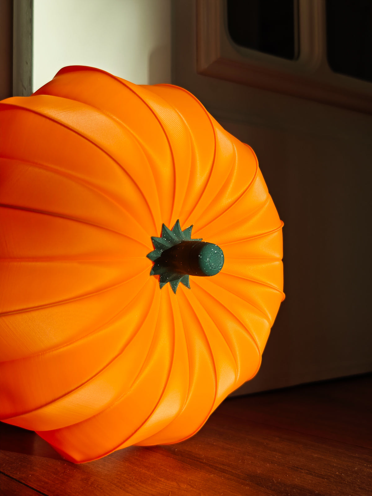 White sculptural pumpkin form held in hand