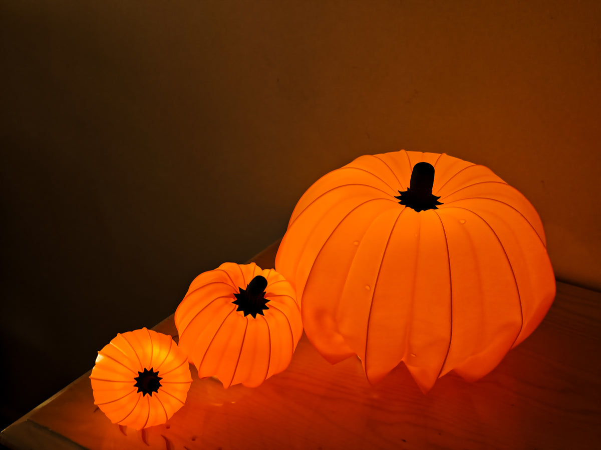 Two white pumpkins on tabletop