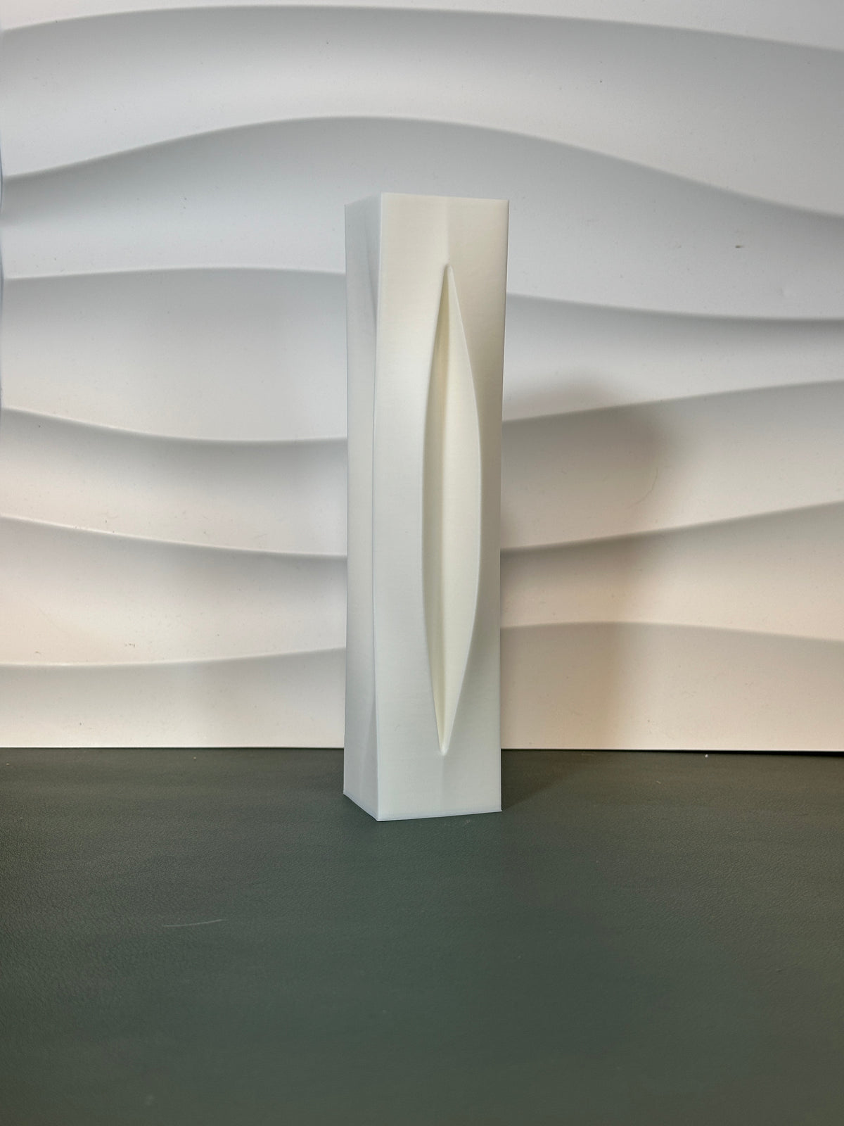 Sleek Modern Aperture Vase dark grey real product on kraft paper with white ceramic fragments and eucalyptus lifestyle