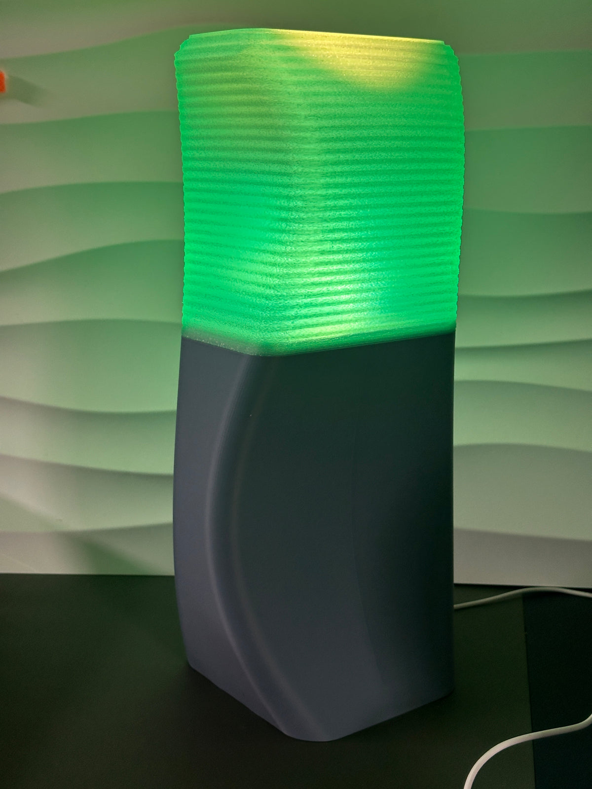 Elegant Sweeping Curve Lamp green shade detail close up showing ribbed texture and glow