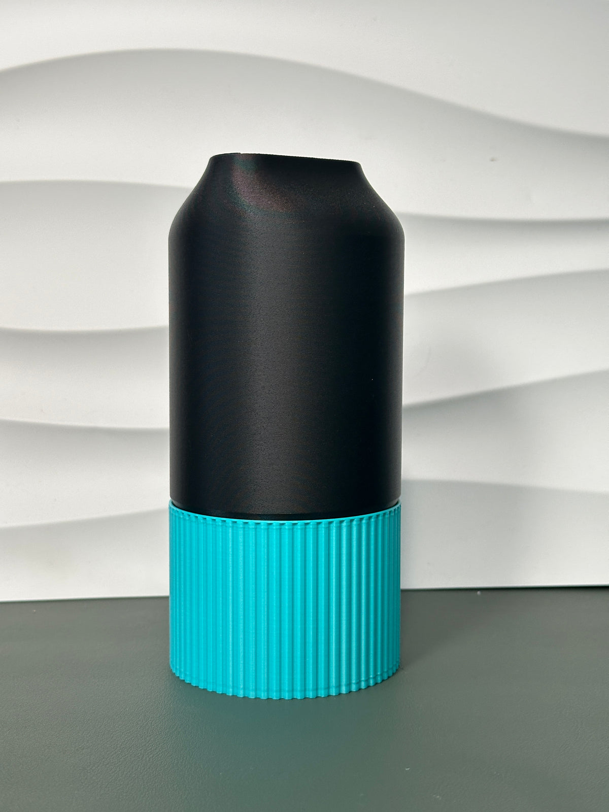 Elegant Two-Part Slot Vase black teal real product front view wavy white wall background