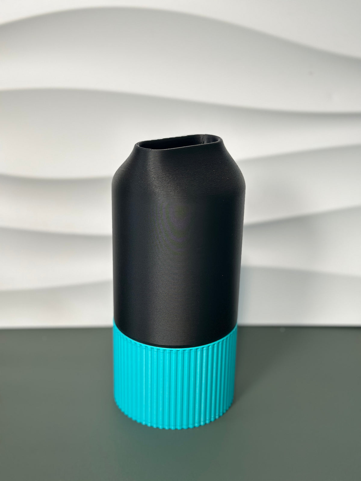 Elegant Two-Part Slot Vase black teal real product side view on dark grey surface