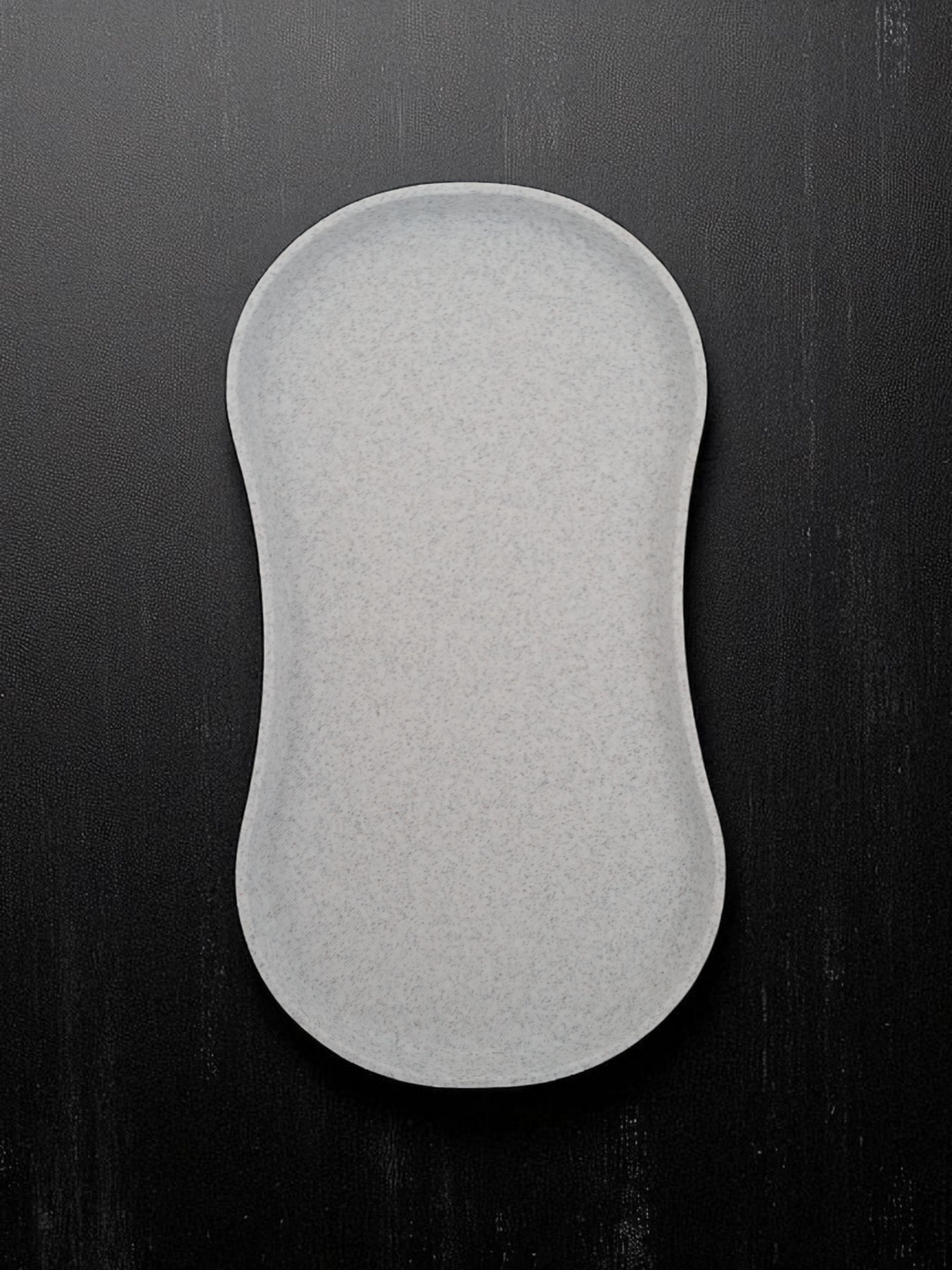 Kitchen Utensil Tray - beige/natural colourway flat lay on black surface showing full kidney-shaped form and raised edges