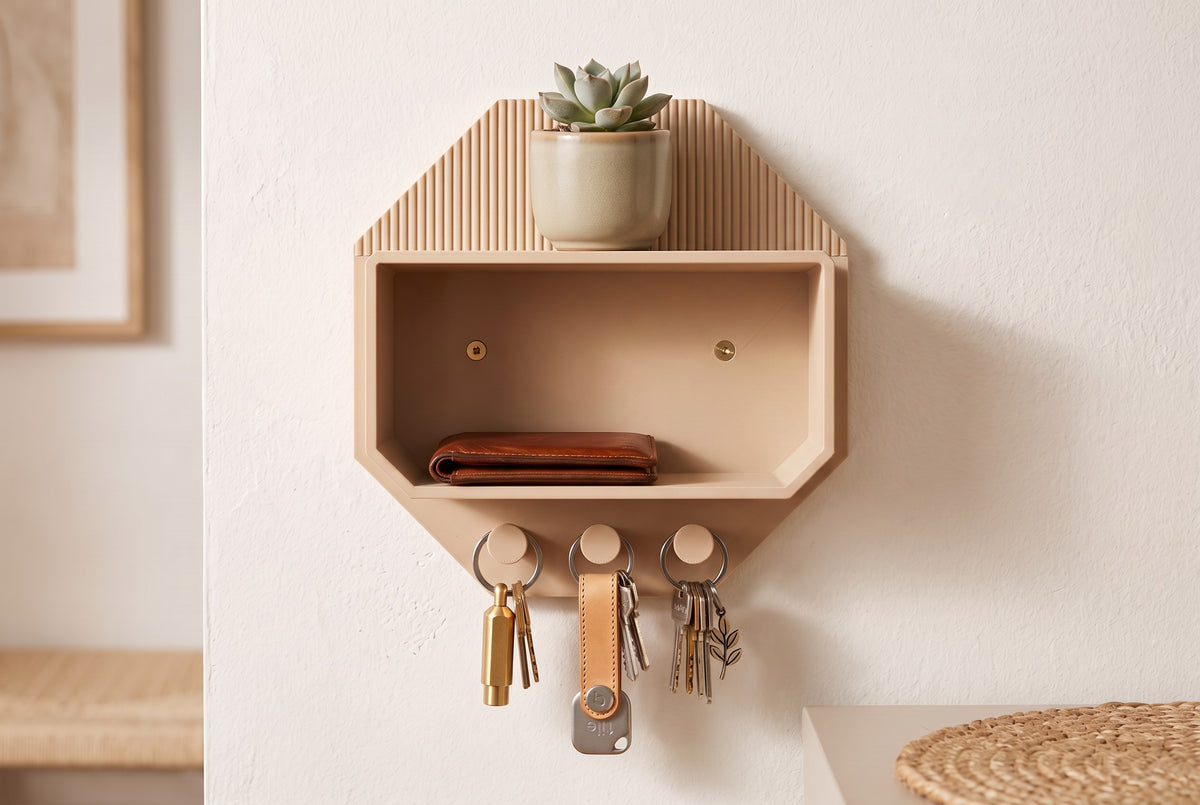 Octagonal beige wall shelf with a succulent, brown wallet, sunglasses and keys on hooks