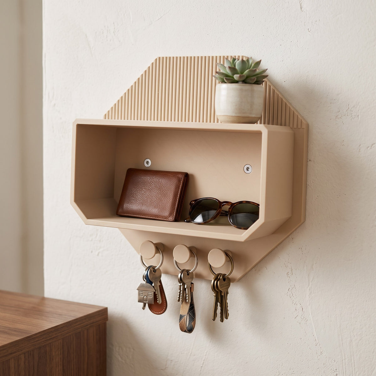 Octagonal beige wall shelf with black sunglasses, a wallet and keys on hooks