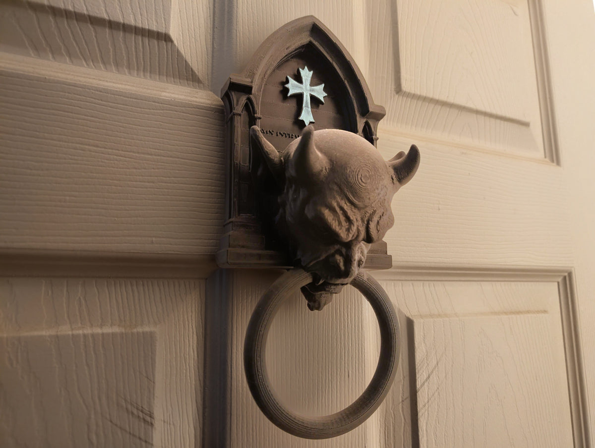Side profile of gargoyle door knocker on door
