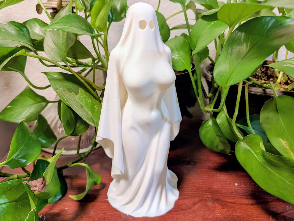 White Ghost Lady figurine beside measuring grid