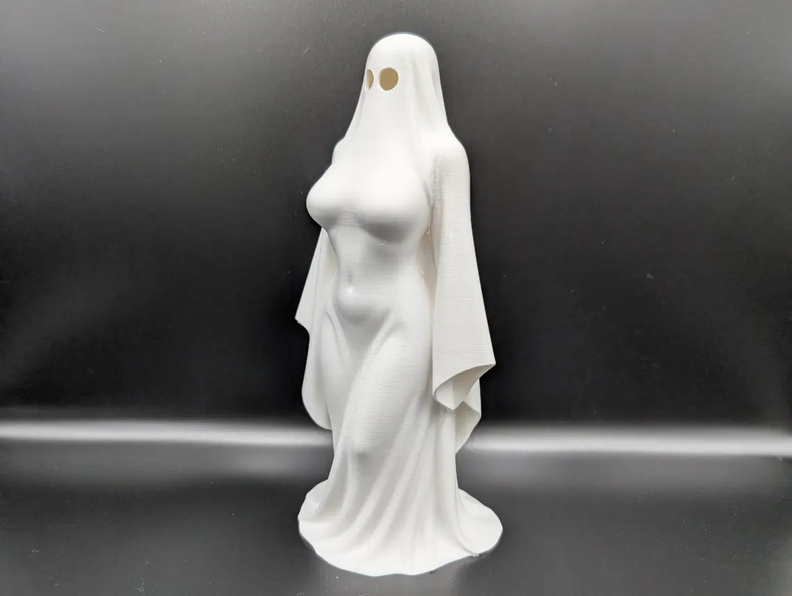 White Ghost Lady figurine held to show scale
