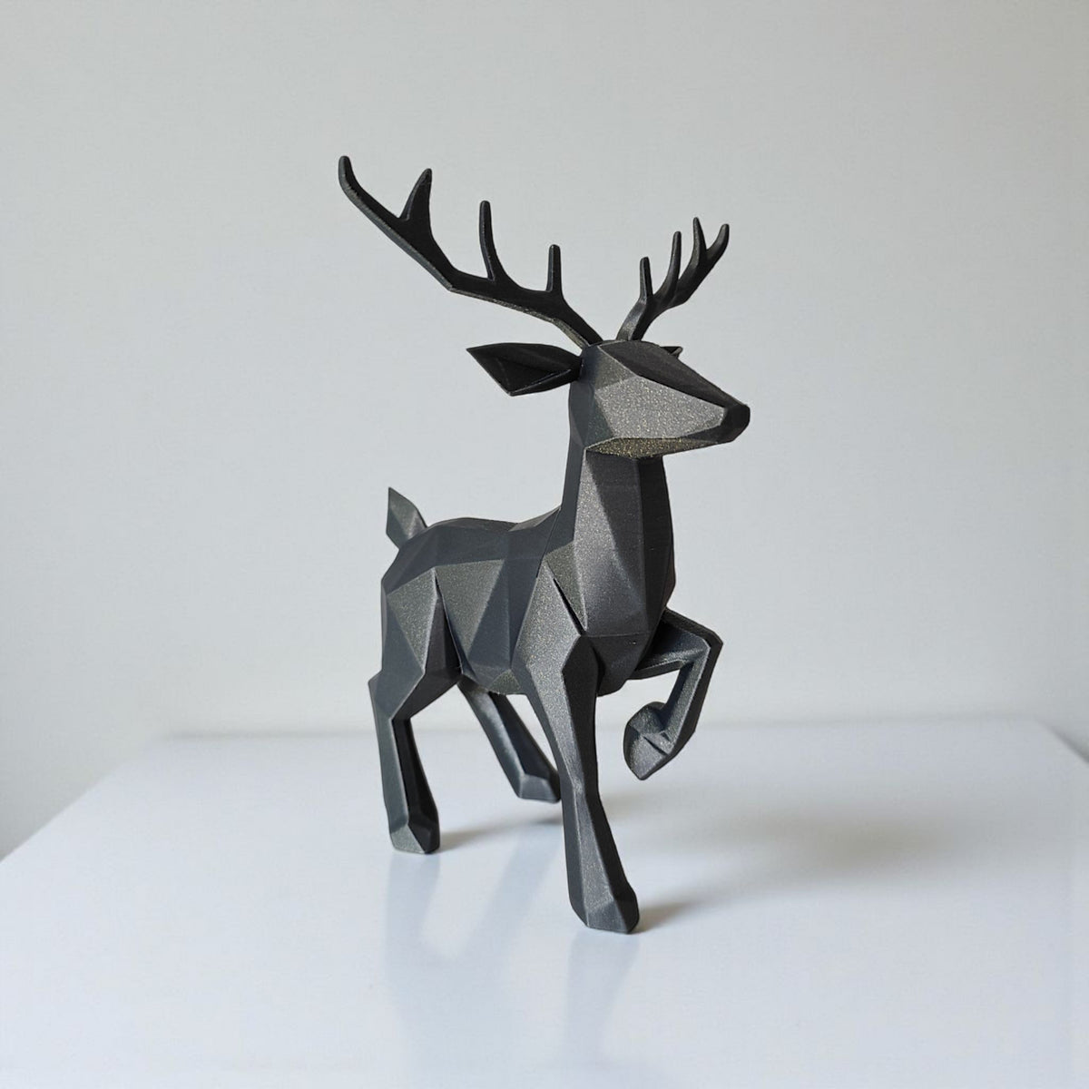 Low poly reindeer on mantelpiece with candles and red baubles