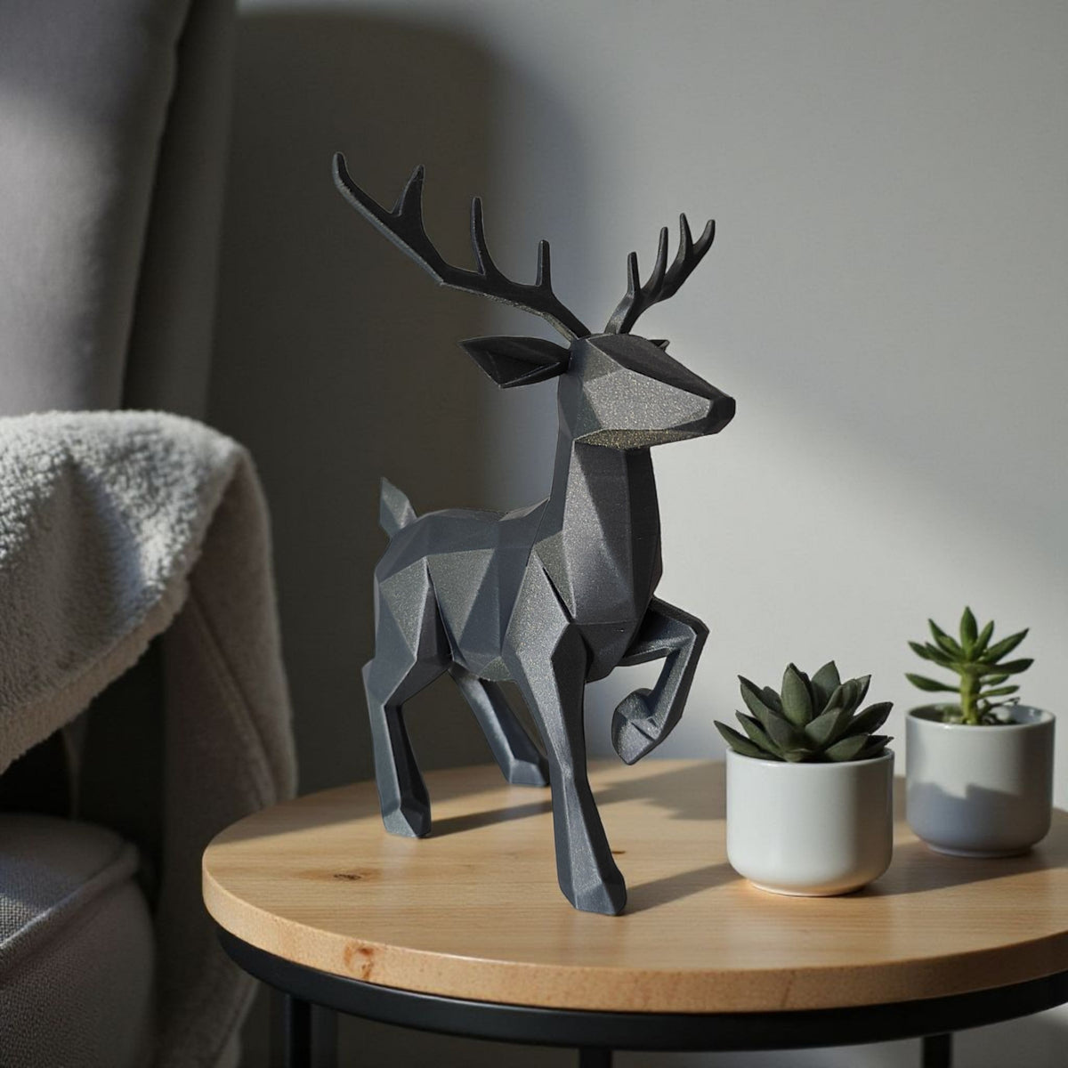 Low poly reindeer with Christmas baubles and pine branches