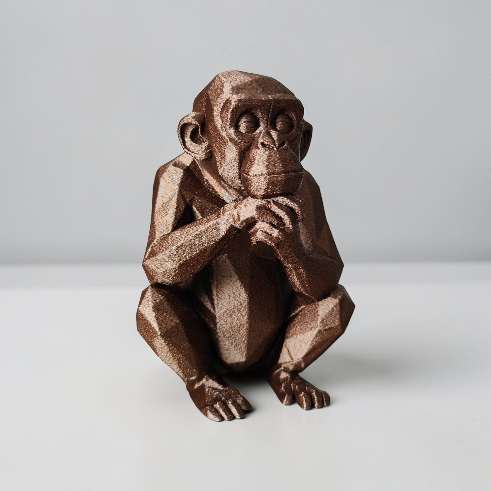 Thoughtful Low-Poly Chimpanzee Sculpture