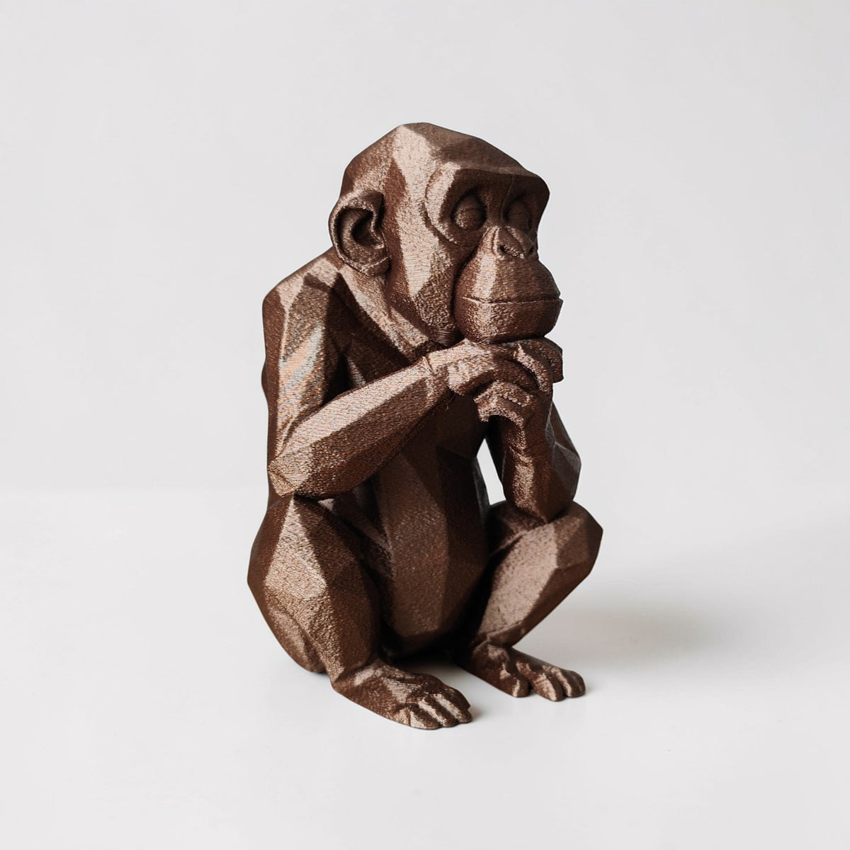 Thoughtful Low-Poly Chimpanzee Sculpture