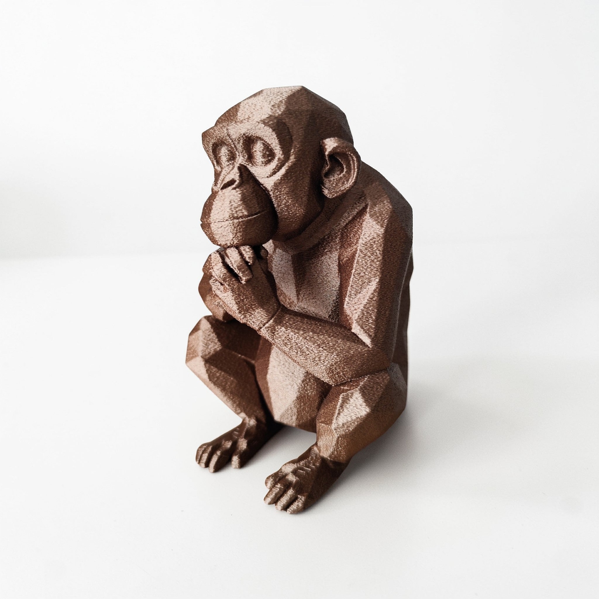 Thoughtful Low-Poly Chimpanzee Sculpture