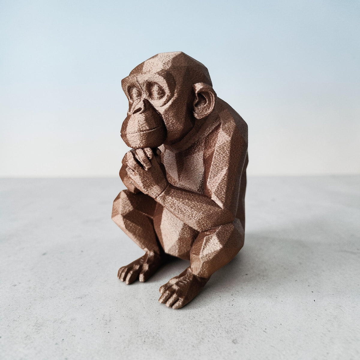 Thoughtful Low-Poly Chimpanzee Sculpture