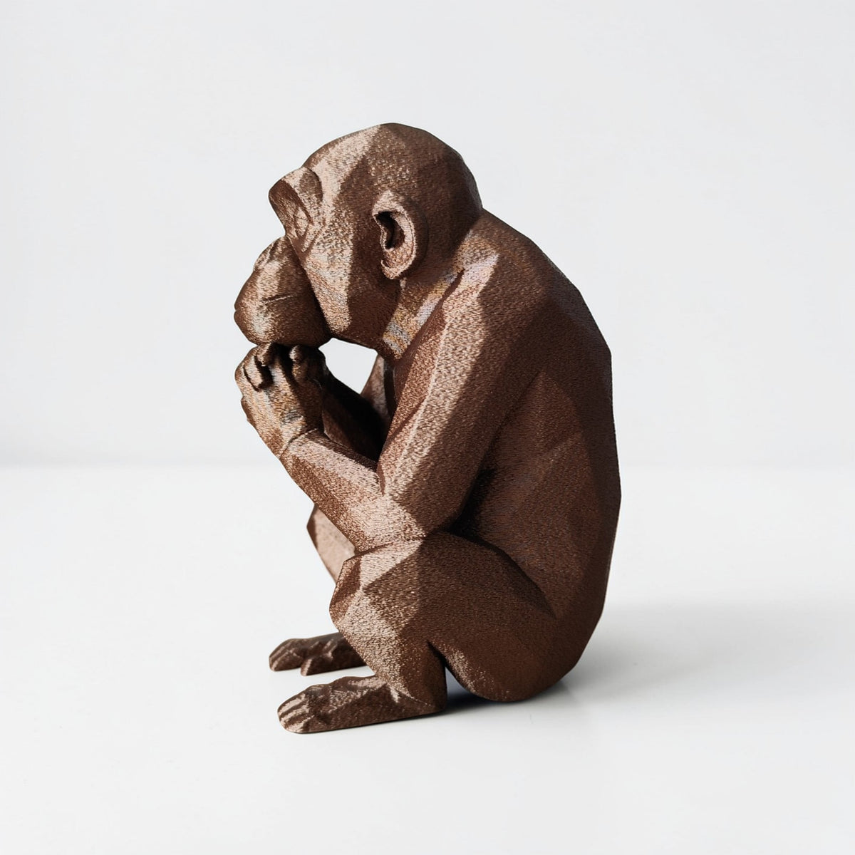 Thoughtful Low-Poly Chimpanzee Sculpture