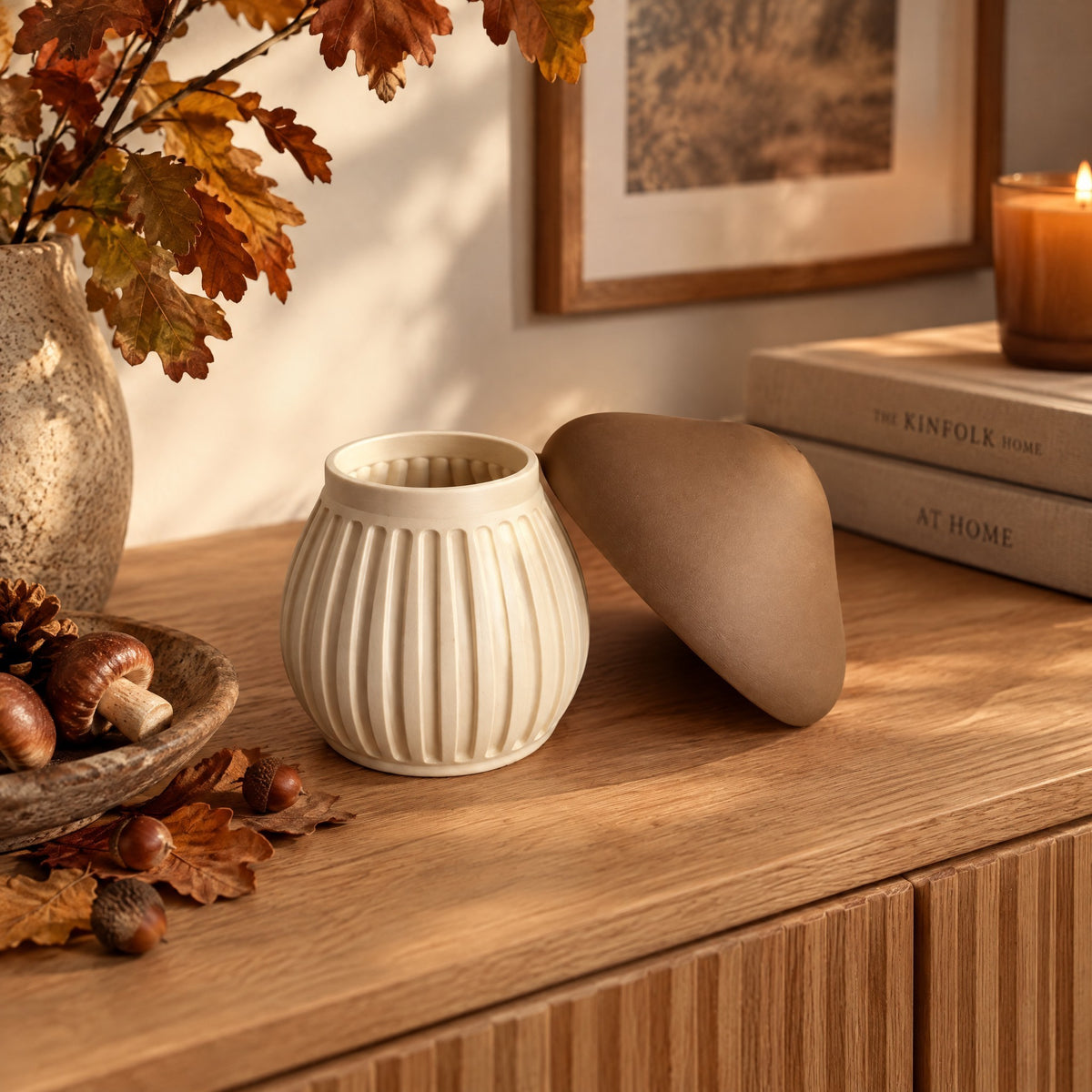 Modern ribbed mushroom-shaped container in a warm autumn setting