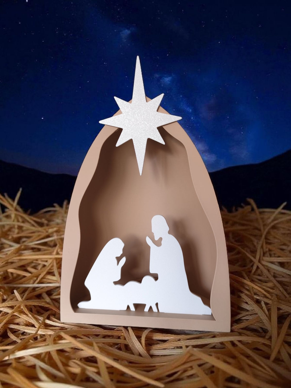 Close-up of star on nativity scene with richly decorated mantelpiece above