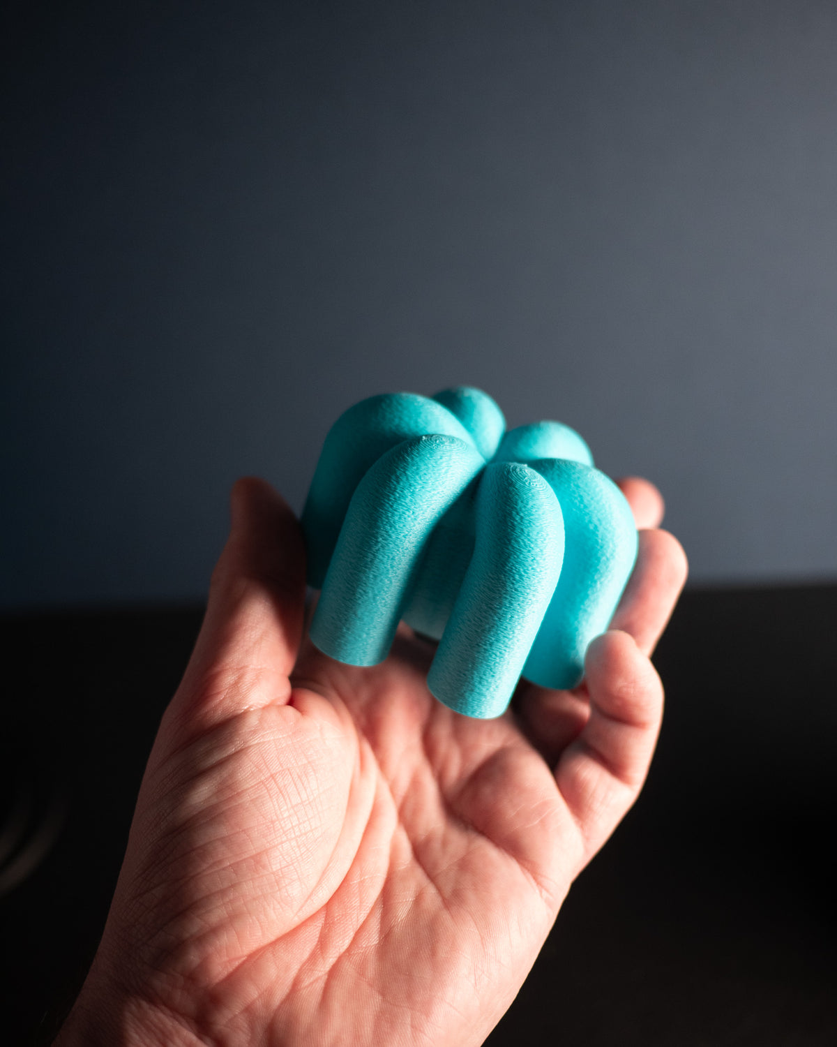Wibble Cabinet Handle — mint green side view on white cabinet edge