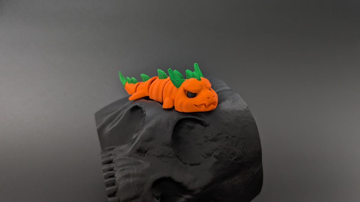 Pumpkin dragon perched on skull prop