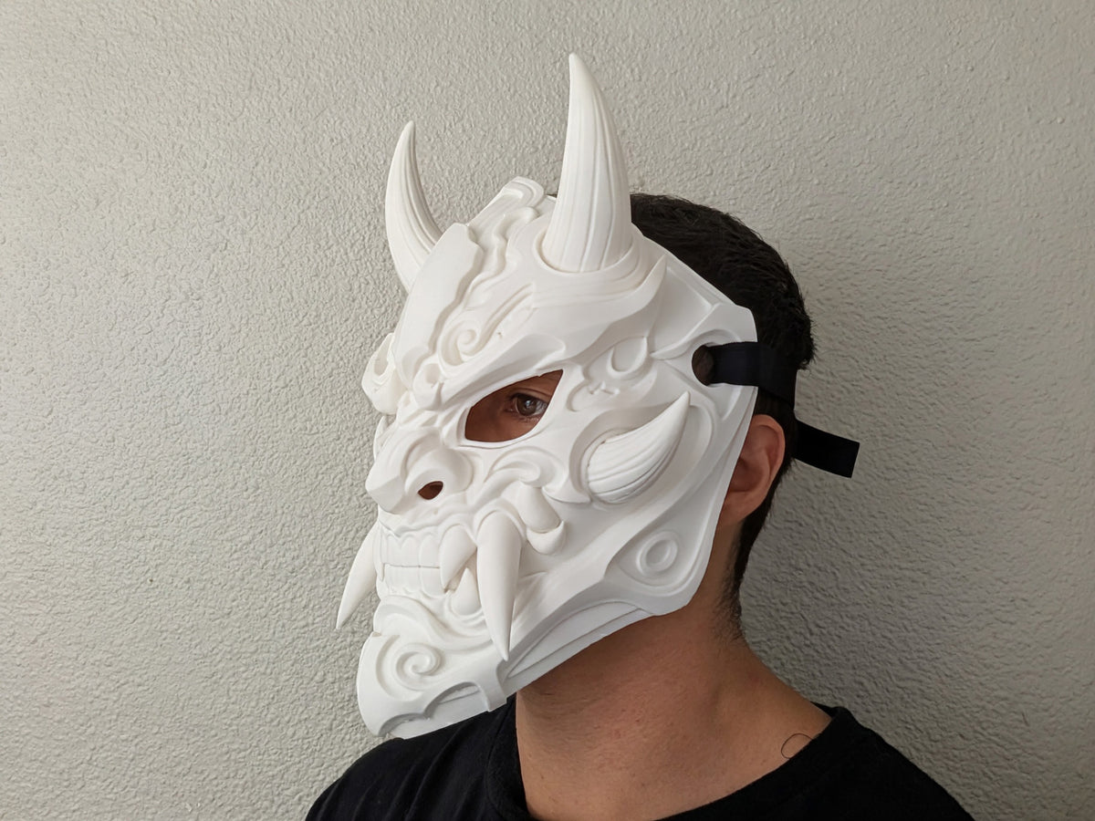 Front view of the Oni Demon Mask showing its horns, tusks, fangs and ornamental details.